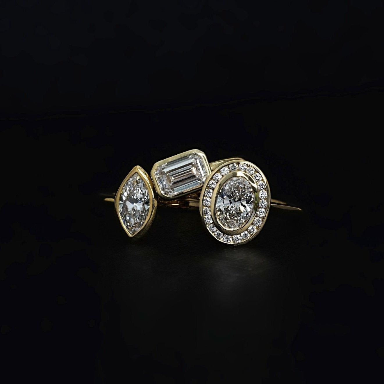 Rings-The Georgia engagement ring showcases a stunning oval diamond in a sleek bezel setting, surrounded by a halo of channel set diamonds. Crafted with a comfort fit band, this design combines clean lines with understated brilliance. Its timeless elegance makes it a sophisticated choice for those seeking a modern yet classic look.-ELIISE MAAR JEWELLERY