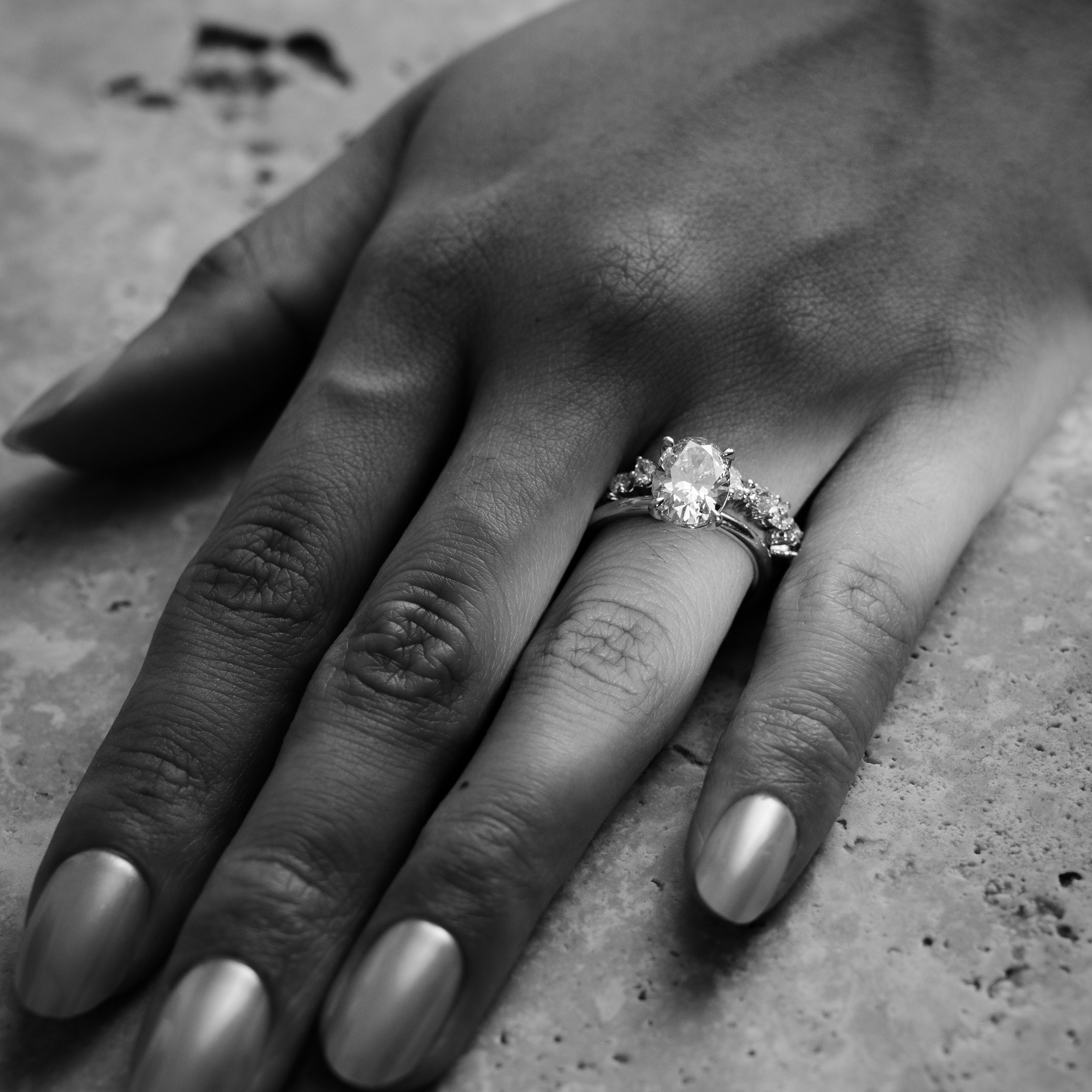 Rings-Drawing inspiration from Grace Kelly, this solitaire ring embodies timeless elegance. Featuring a 4-claw setting and a smoothly rounded band, it offers a subtle frame that highlights the radiant oval diamond at its center. An ideal engagement ring, it complements any wedding band to form a distinctive and personalized set. Shown paired with the 4.0mm Ceremonial Square Band and the Eleanor Luxe Diamond Band.-ELIISE MAAR JEWELLERY