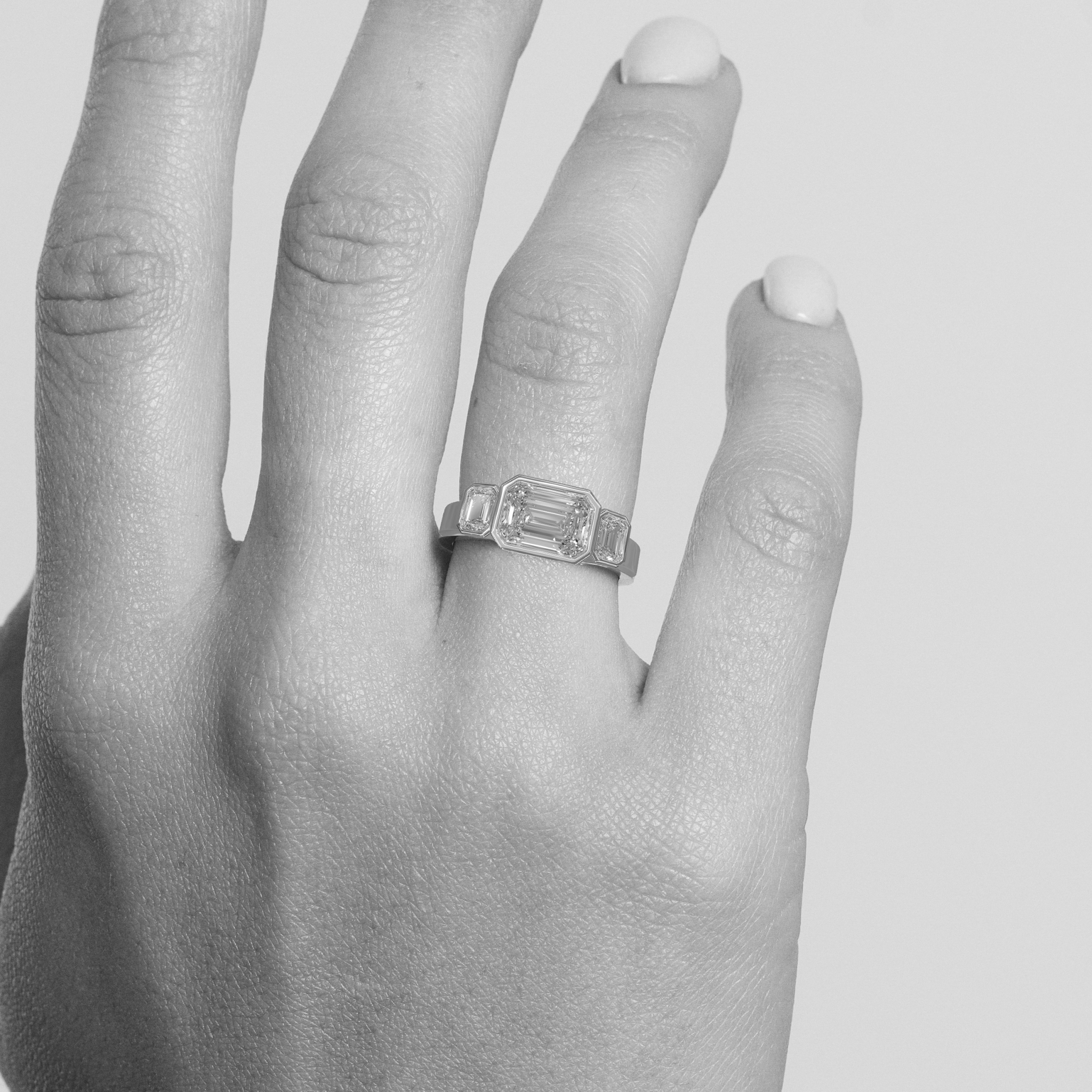 Rings-In the realm of timeless romance, the HERR Diamond Trilogy Ring stands as a beacon of enduring love and shared destiny. Featuring an east-west emerald-cut centre stone, flanked by two complementary emerald-cut diamonds. Cradled in a bezel setting that accentuates their brilliance, the trilogy symbolizes the cherished past, vibrant present, and boundless future of a couple's journey together. As part of the esteemed Le Courage collection, the HERR Diamond Trilogy Ring celebrates the courage inherent in