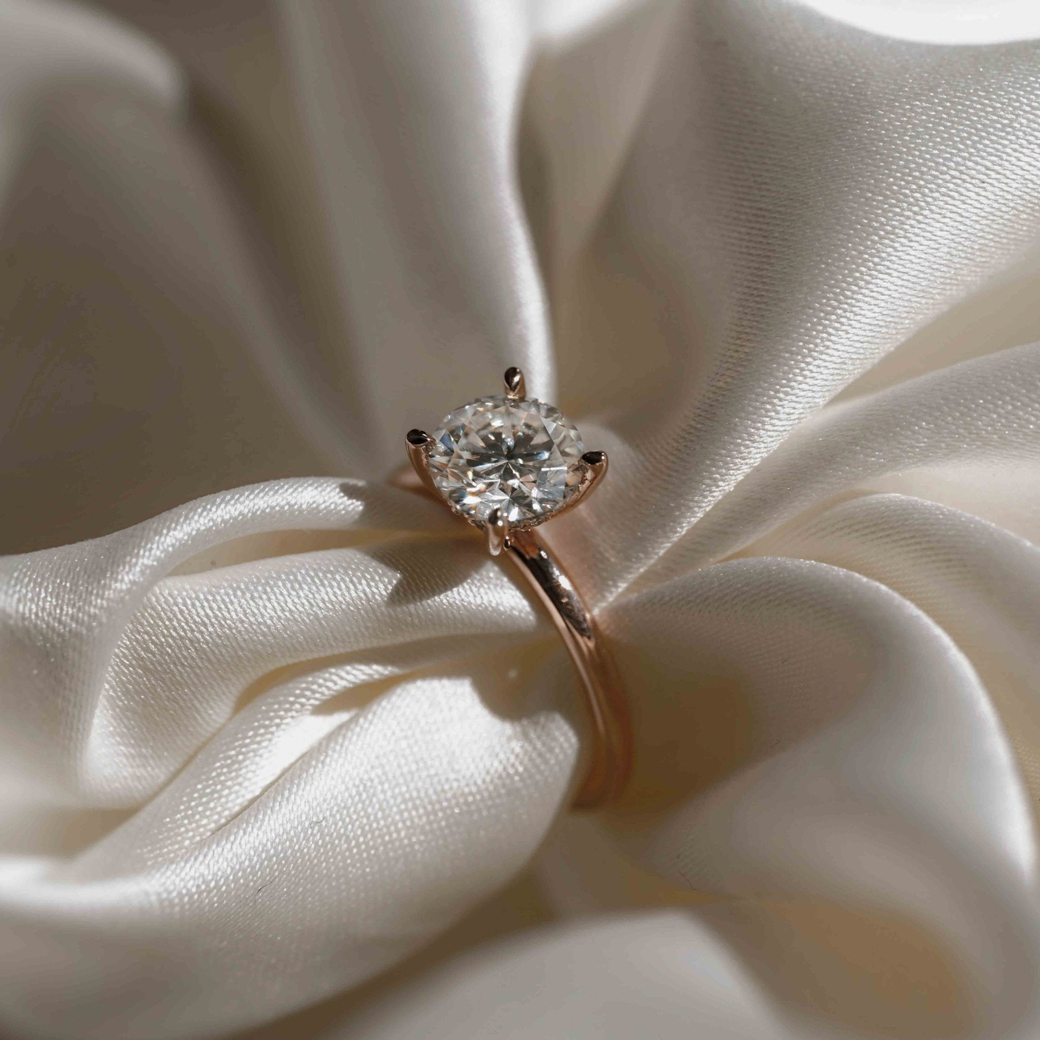 Rings-An elevated solitaire. With a beautiful round cut centre stone and hidden halo on the girdle of the 4 claw basket. The hidden halo provides a beautiful added sparkle to the ring from all angles without interfering with the power of the centre stone. This ring pairs beautifully with wedding bands, we recommend trying the Petite Josephine and the Eleanor.-ELIISE MAAR JEWELLERY