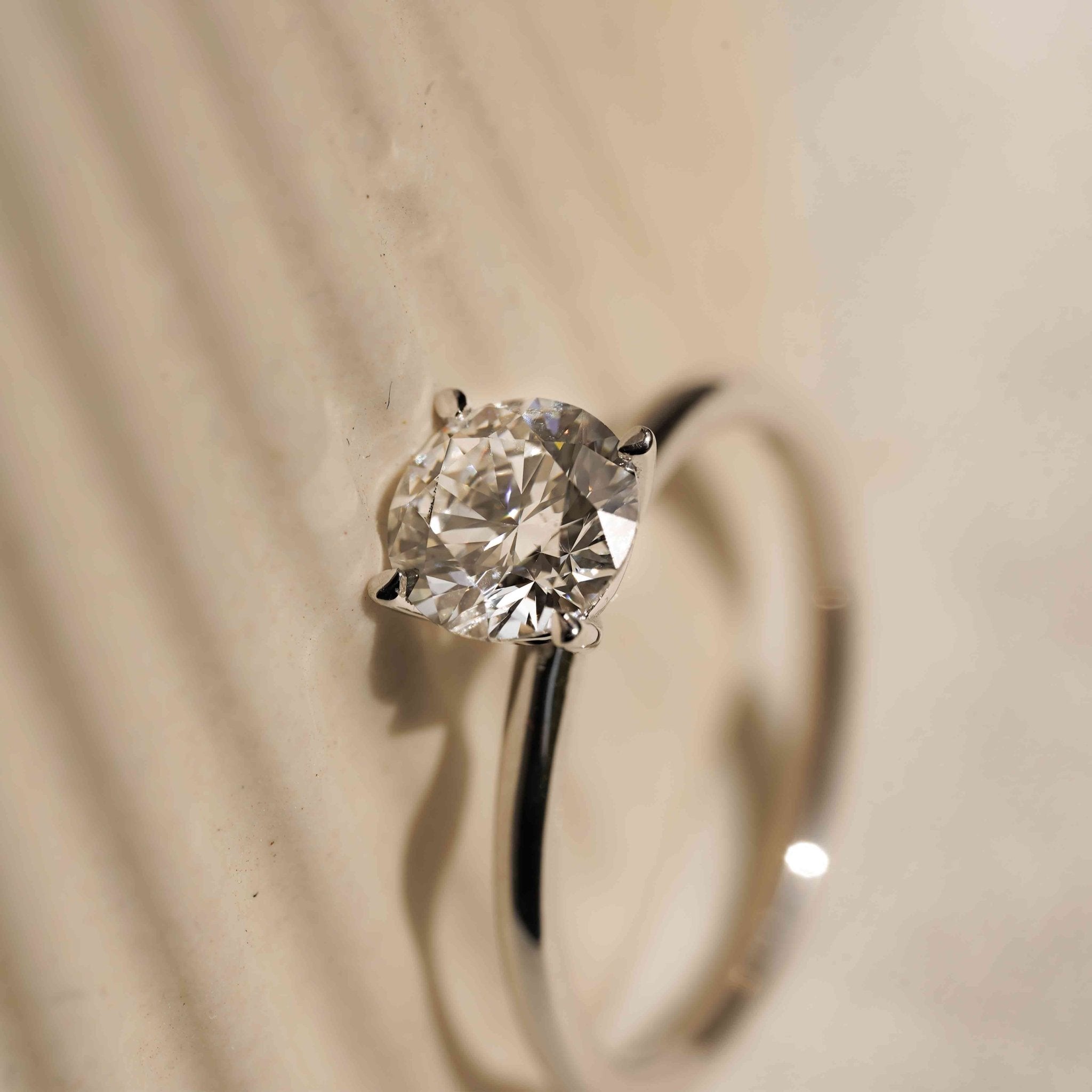 Rings-An elevated solitaire. With a beautiful round cut centre stone and hidden halo on the girdle of the 4 claw basket. The hidden halo provides a beautiful added sparkle to the ring from all angles without interfering with the power of the centre stone. This ring pairs beautifully with wedding bands, we recommend trying the Petite Josephine and the Eleanor.-ELIISE MAAR JEWELLERY