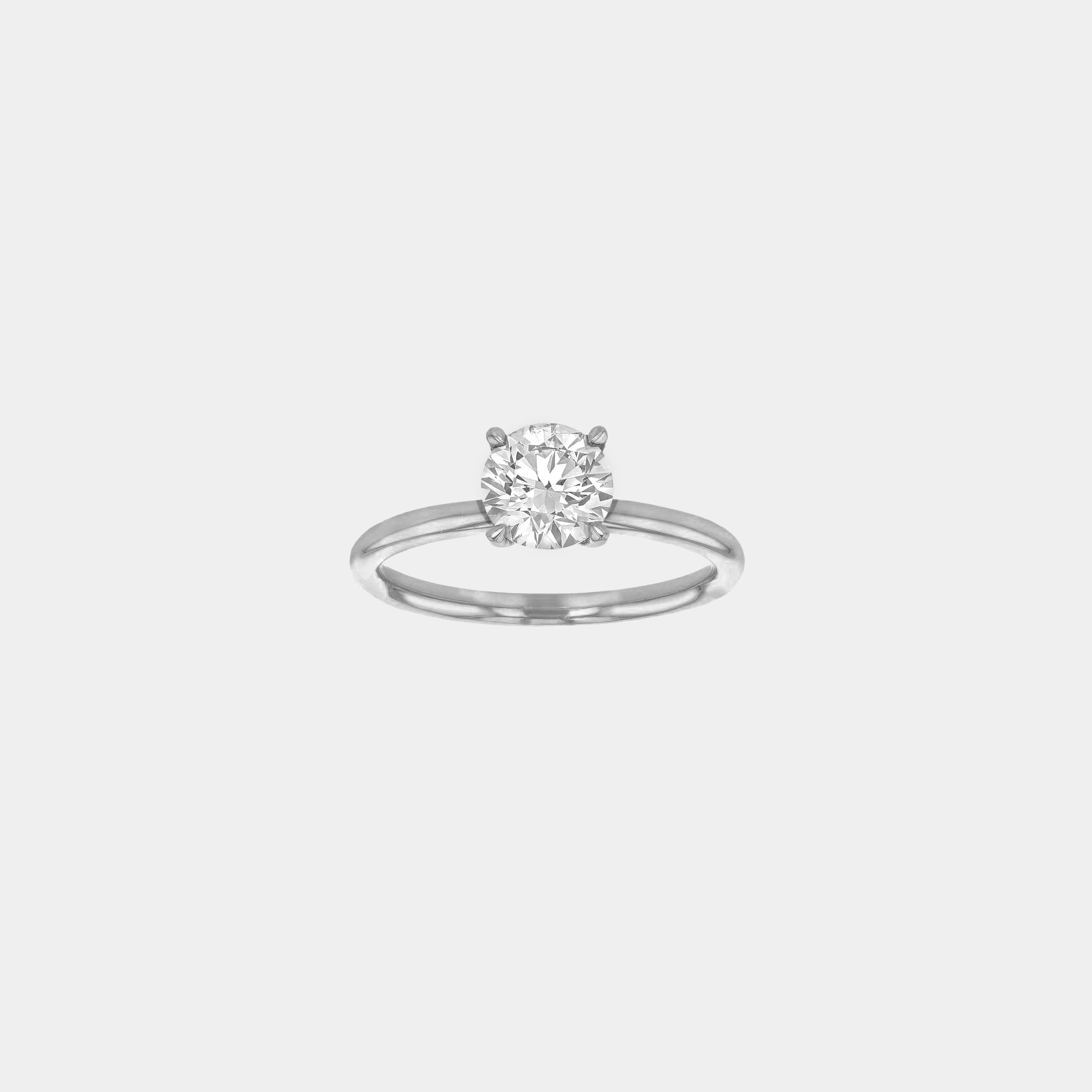 Rings-An elevated solitaire. With a beautiful round cut centre stone and hidden halo on the girdle of the 4 claw basket. The hidden halo provides a beautiful added sparkle to the ring from all angles without interfering with the power of the centre stone. This ring pairs beautifully with wedding bands, we recommend trying the Petite Josephine and the Eleanor.-ELIISE MAAR JEWELLERY
