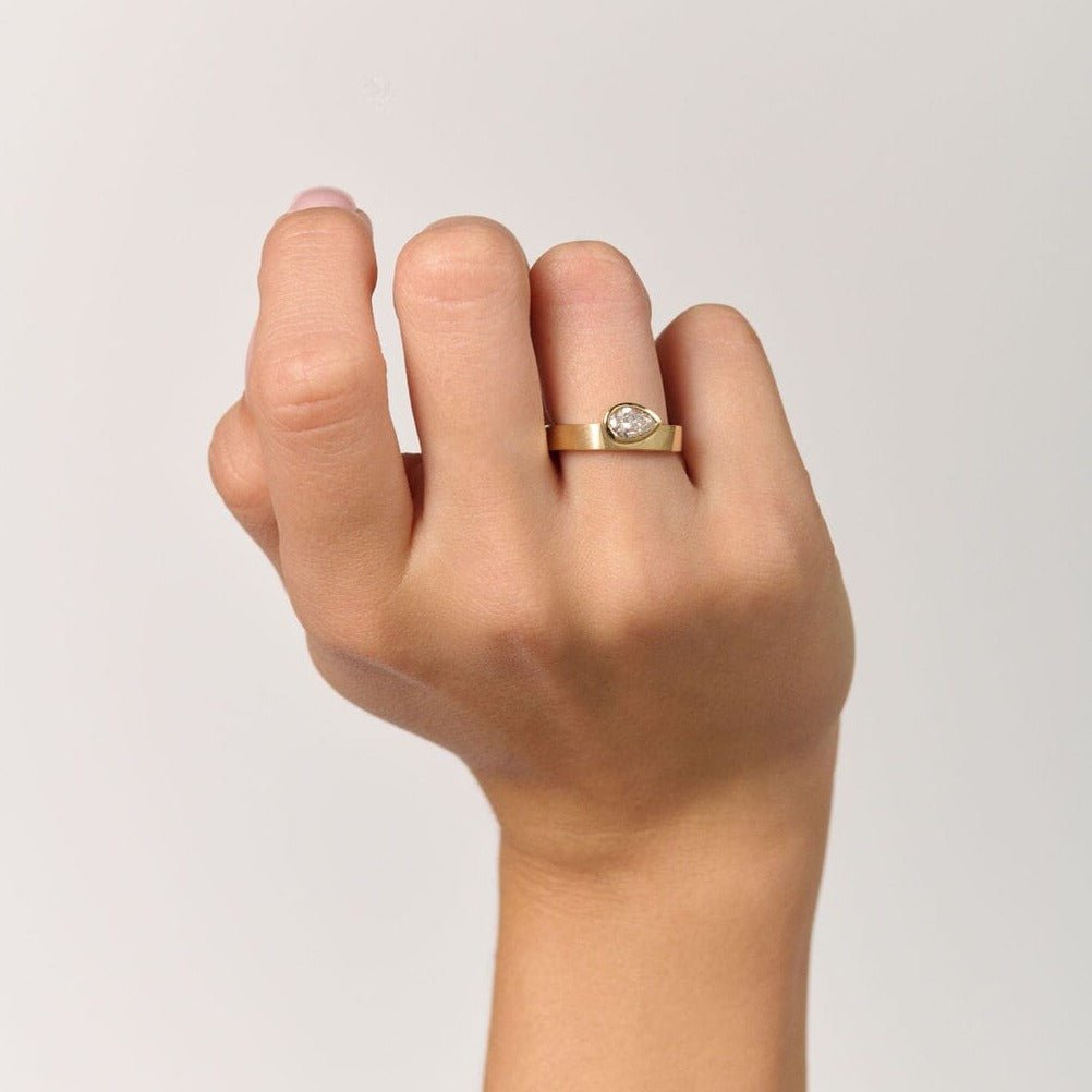 Rings-The Kali draws inspiration from her namesake Hindu goddess of time, change, creation and power. Known as being a defender of innocence Kali is a force to be reckoned with. The striking pear cut stone set in the thick band represents the divine female power that Kali embodies.-ELIISE MAAR JEWELLERY