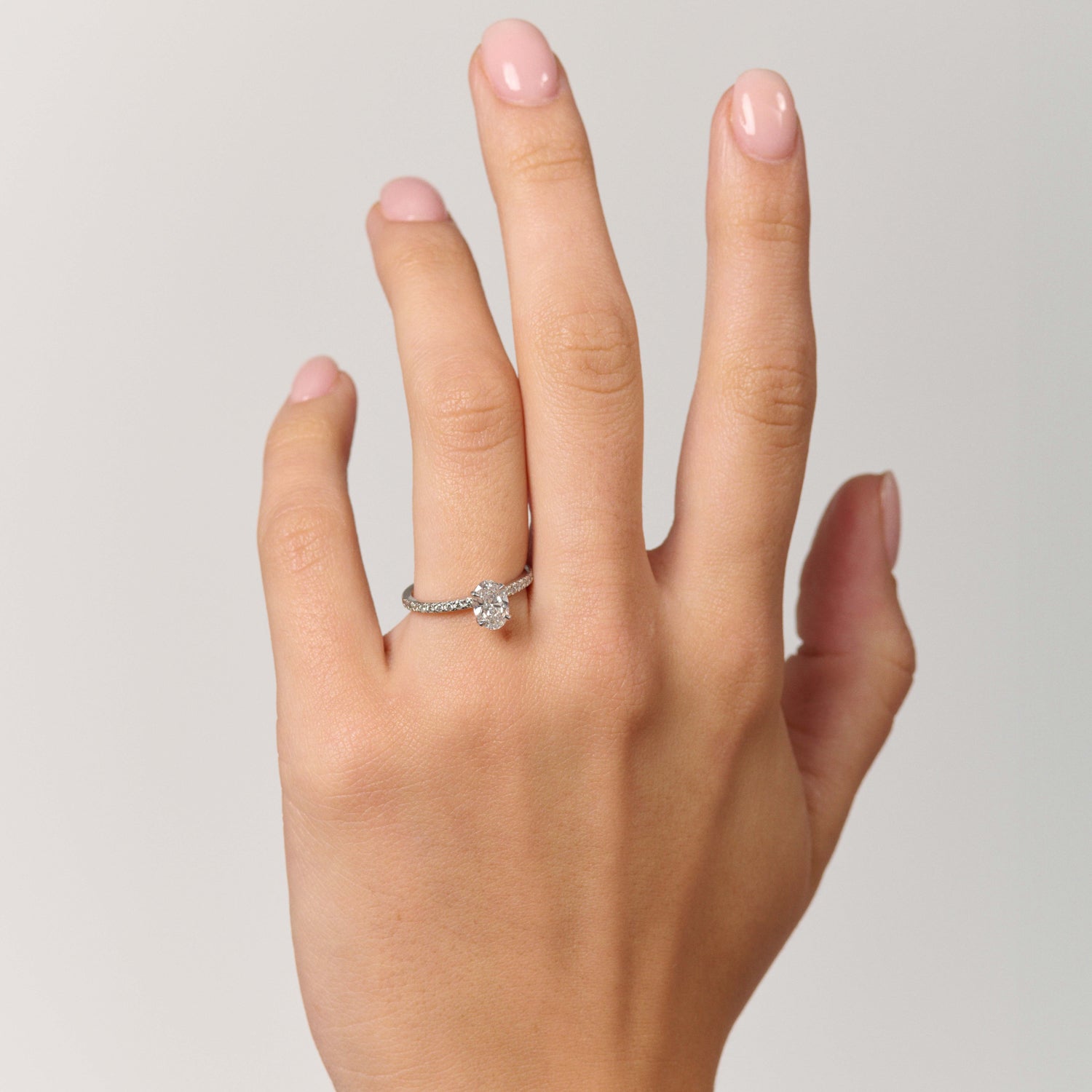 Rings-A elegant engagement ring with a beautiful half eternity pavé diamond band. The striking fire of the side diamonds enhance the brilliance of the oval cut centre diamond. Pair the Lena with with Fine Lavish diamond band for a matching set. Available with an oval or pear shaped diamond.-ELIISE MAAR JEWELLERY