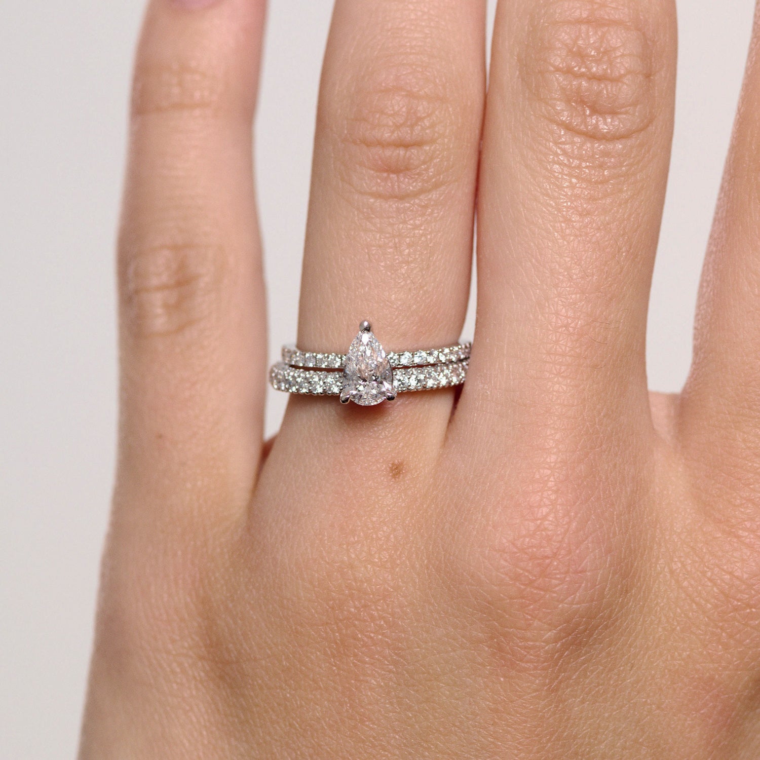 Rings-A elegant engagement ring with a beautiful half eternity pavé diamond band. The striking fire of the side diamonds enhance the brilliance of the oval cut centre diamond. Pair the Lena with with Fine Lavish diamond band for a matching set. Available with an oval or pear shaped diamond.-ELIISE MAAR JEWELLERY