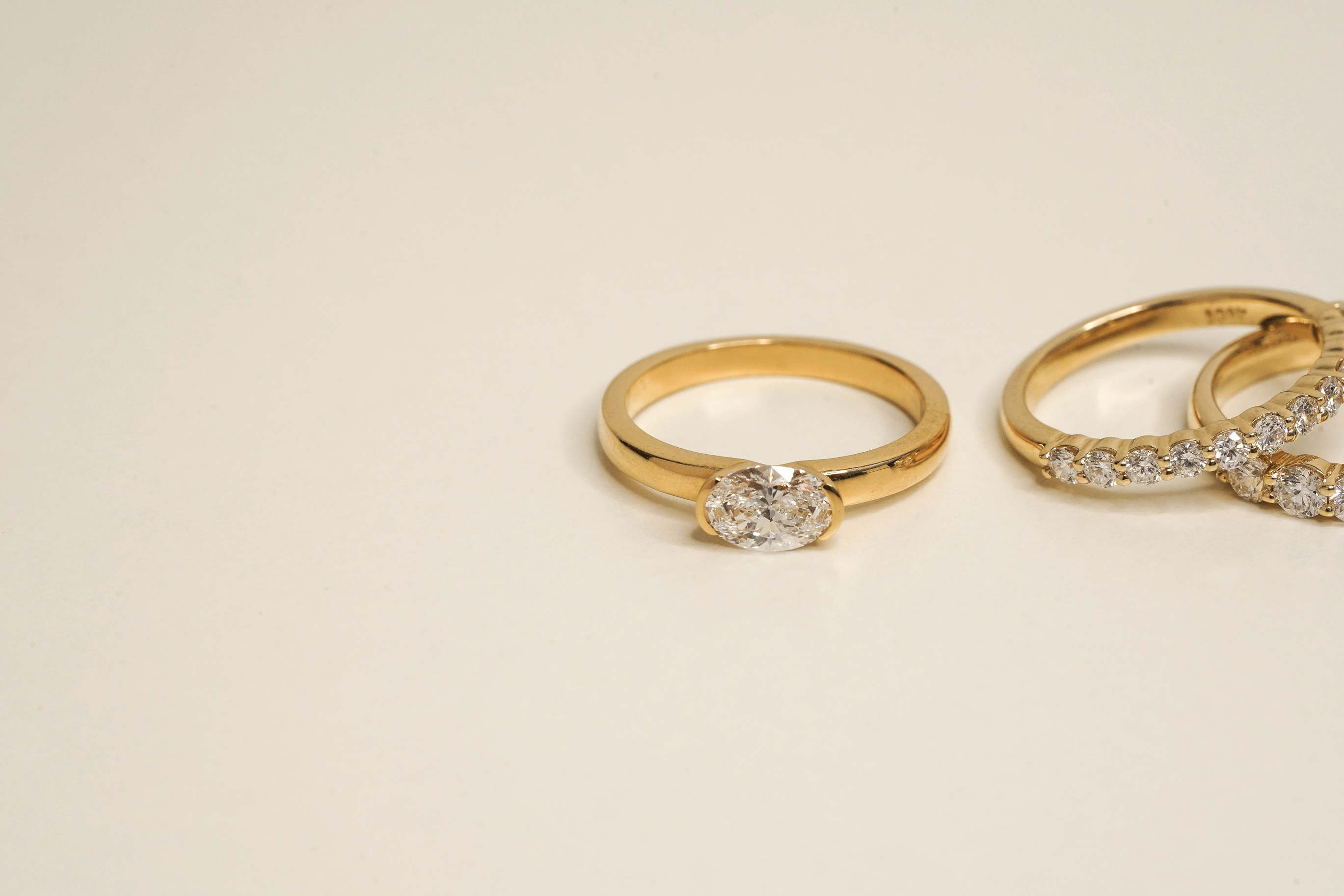 Rings-A contemporary take on the classic solitaire, the Margot is designed for the modern wearer. With an east-west set oval cut center diamond on a thick band, this ring is bold and sleek. See the Margot paired with the Josephine Luxe Diamond Band. Available with different size oval diamonds. Product images featuring an option with 1.00ct center diamond and 0.70ct diamond.-ELIISE MAAR JEWELLERY