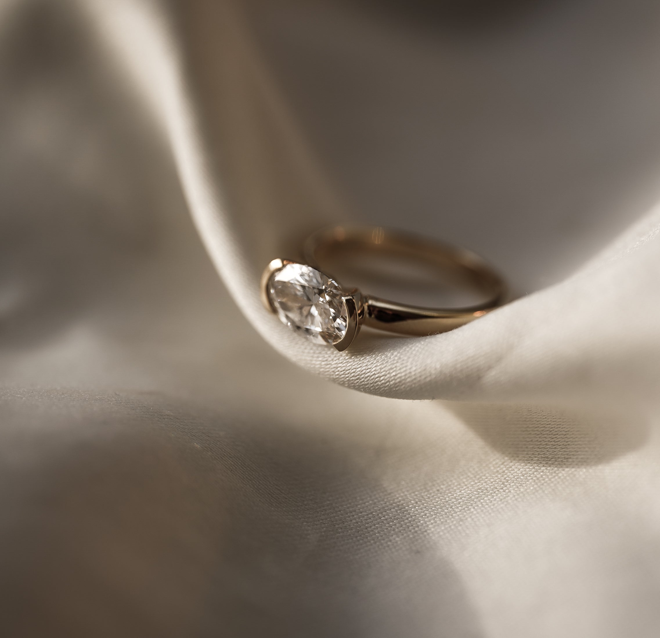 Rings-A contemporary take on the classic solitaire, the Margot is designed for the modern wearer. With an east-west set oval cut center diamond on a thick band, this ring is bold and sleek. See the Margot paired with the Josephine Luxe Diamond Band. Available with different size oval diamonds. Product images featuring an option with 1.00ct center diamond and 0.70ct diamond.-ELIISE MAAR JEWELLERY