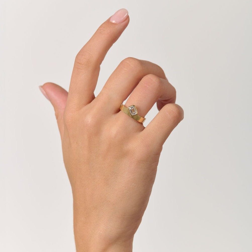 Rings-Part of the Le Courage collection, the Morgan is inspired by the powerful Celtic Goddess of War, Fate and Death who is called on for protection and inspiration. The strong straight windows of the emerald cut stone on the thick gold band pay homage to the courage and strength this mysterious goddess represents.-ELIISE MAAR JEWELLERY