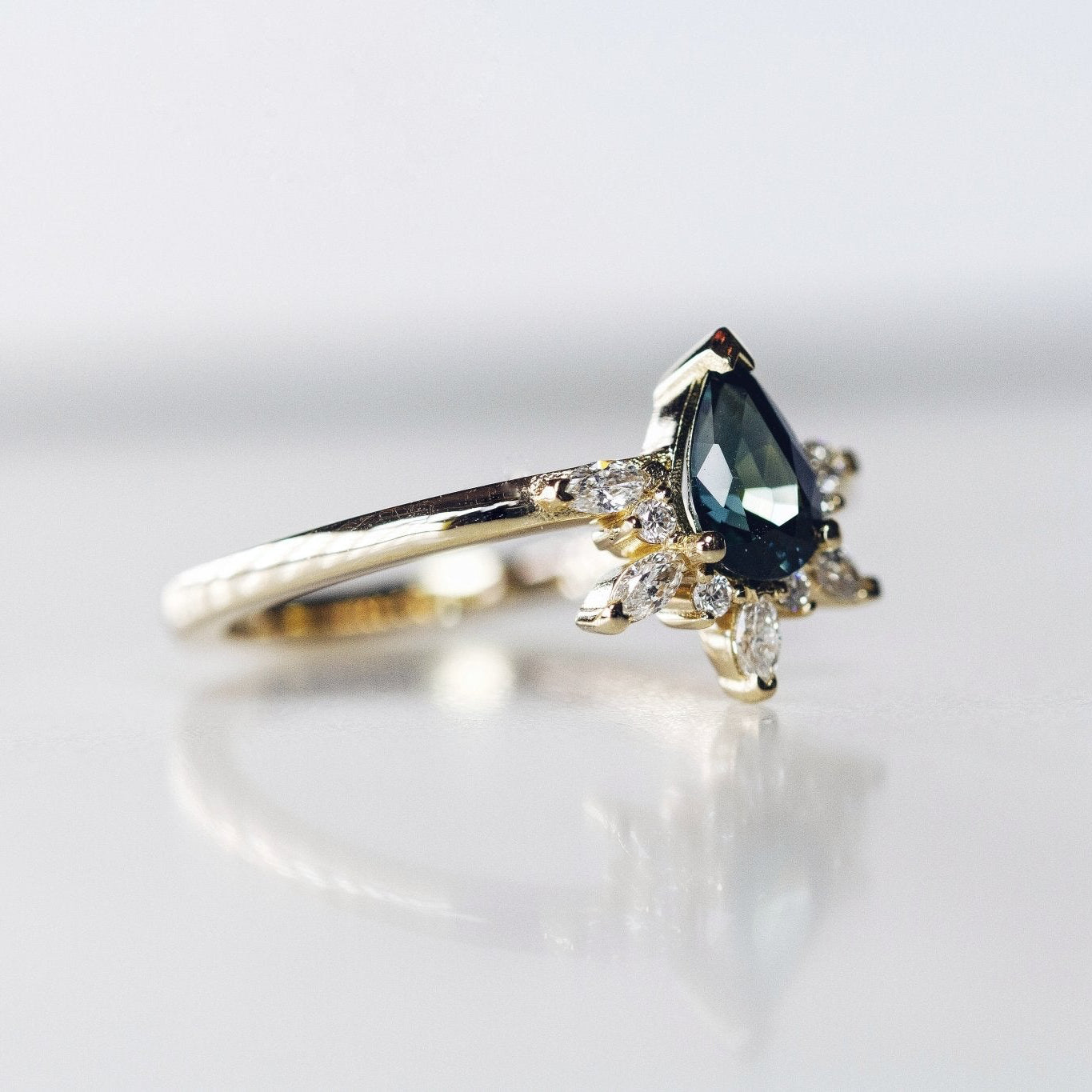 Rings-Feminine, nostalgic nod to the beauty, timelessness and grace of what it means to be woman. Centre stone is a stunning Australian Sapphire completed with a divine diamond halo. Destined to be your forever obsession. Product Details - Features a 0.70ct natural deep blue Australian Sapphire- Half halo features marquise and round F/SI1 natural diamonds (approximately 0.20ct)- Shop the Natasha Diamond Crown to complete the set- The ring is 1.85mm wide and 1.6mm thick-ELIISE MAAR JEWELLERY