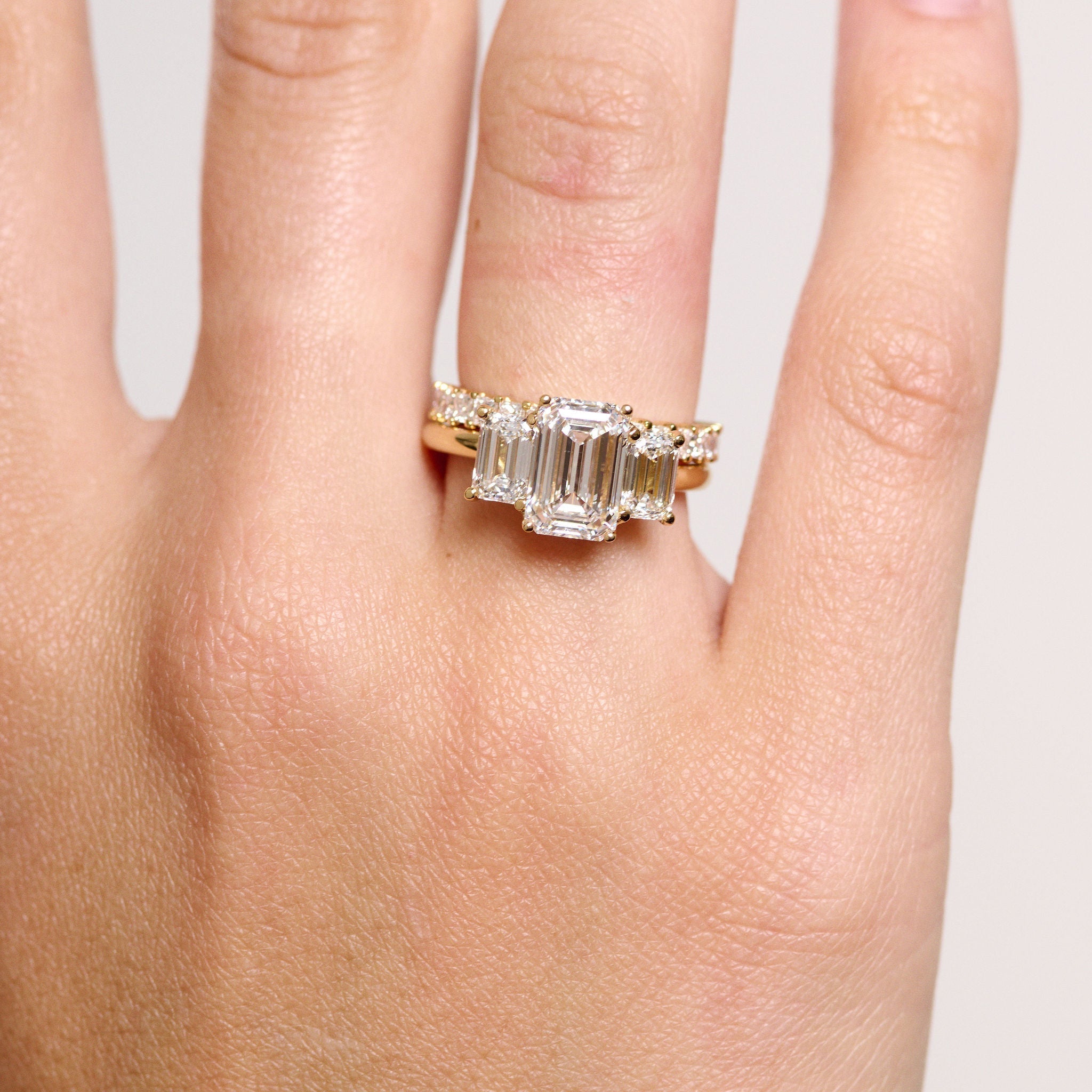 Rings-A stunning trilogy ring featuring three emerald-cut diamonds. Ethereal and breathtaking, this ring is a true testament to the beauty of the emerald-cut diamond. The step cut inside the emerald-cut diamond is famous for its large windows and flashes of bright white light. A ring where the quality and beauty of the diamonds cannot be ignored.-ELIISE MAAR JEWELLERY