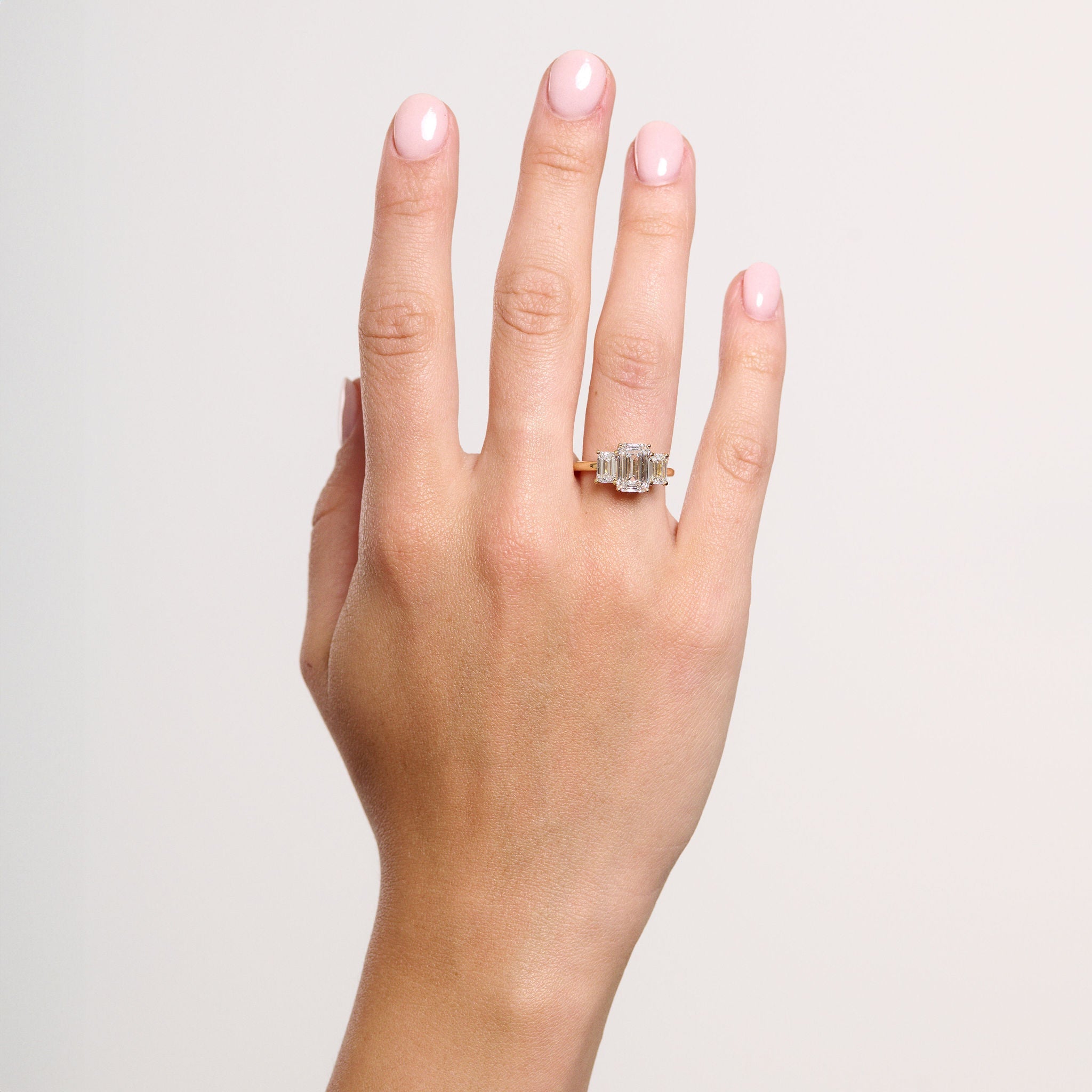 Rings-A stunning trilogy ring featuring three emerald-cut diamonds. Ethereal and breathtaking, this ring is a true testament to the beauty of the emerald-cut diamond. The step cut inside the emerald-cut diamond is famous for its large windows and flashes of bright white light. A ring where the quality and beauty of the diamonds cannot be ignored.-ELIISE MAAR JEWELLERY