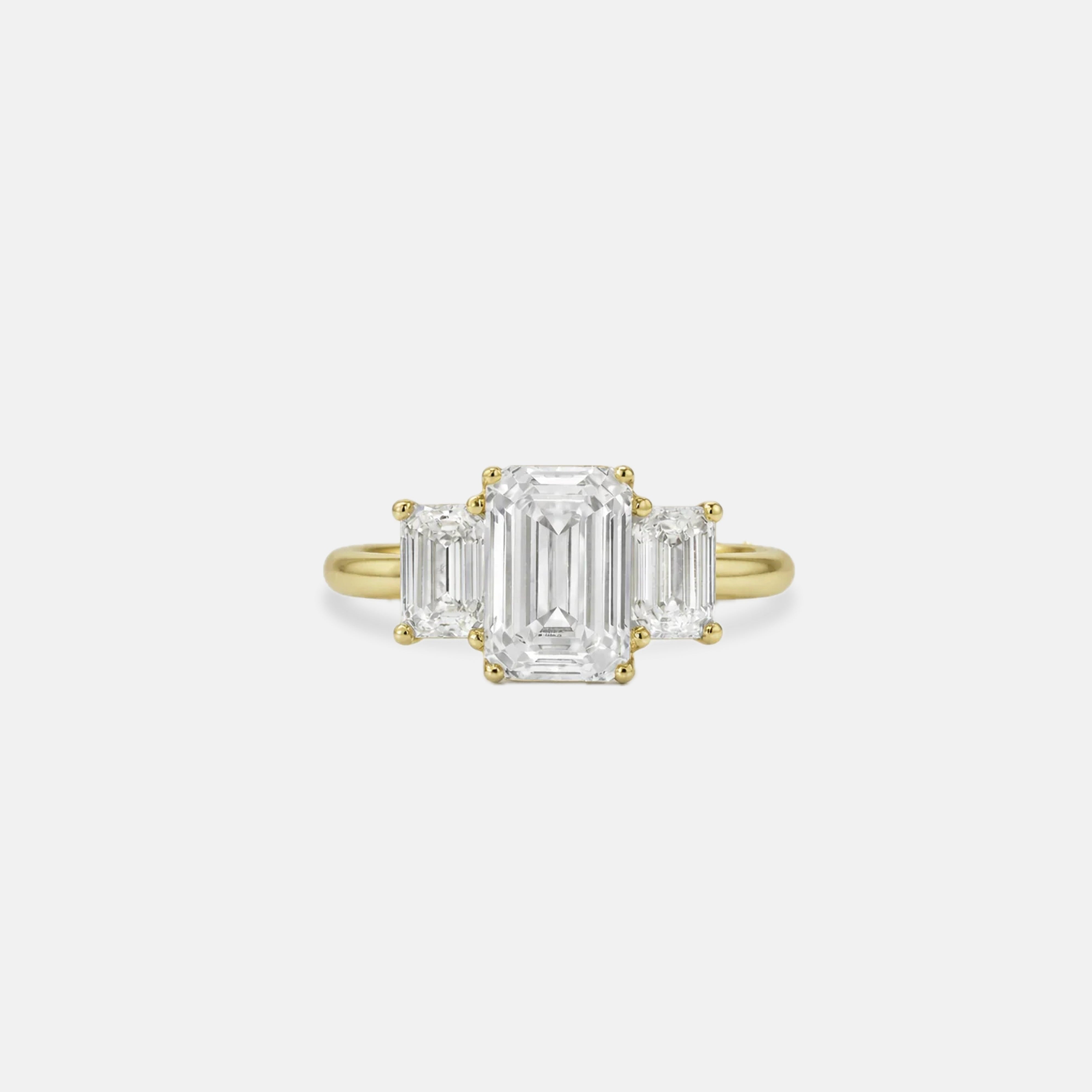 Rings-A stunning trilogy ring featuring three emerald-cut diamonds. Ethereal and breathtaking, this ring is a true testament to the beauty of the emerald-cut diamond. The step cut inside the emerald-cut diamond is famous for its large windows and flashes of bright white light. A ring where the quality and beauty of the diamonds cannot be ignored.-ELIISE MAAR JEWELLERY