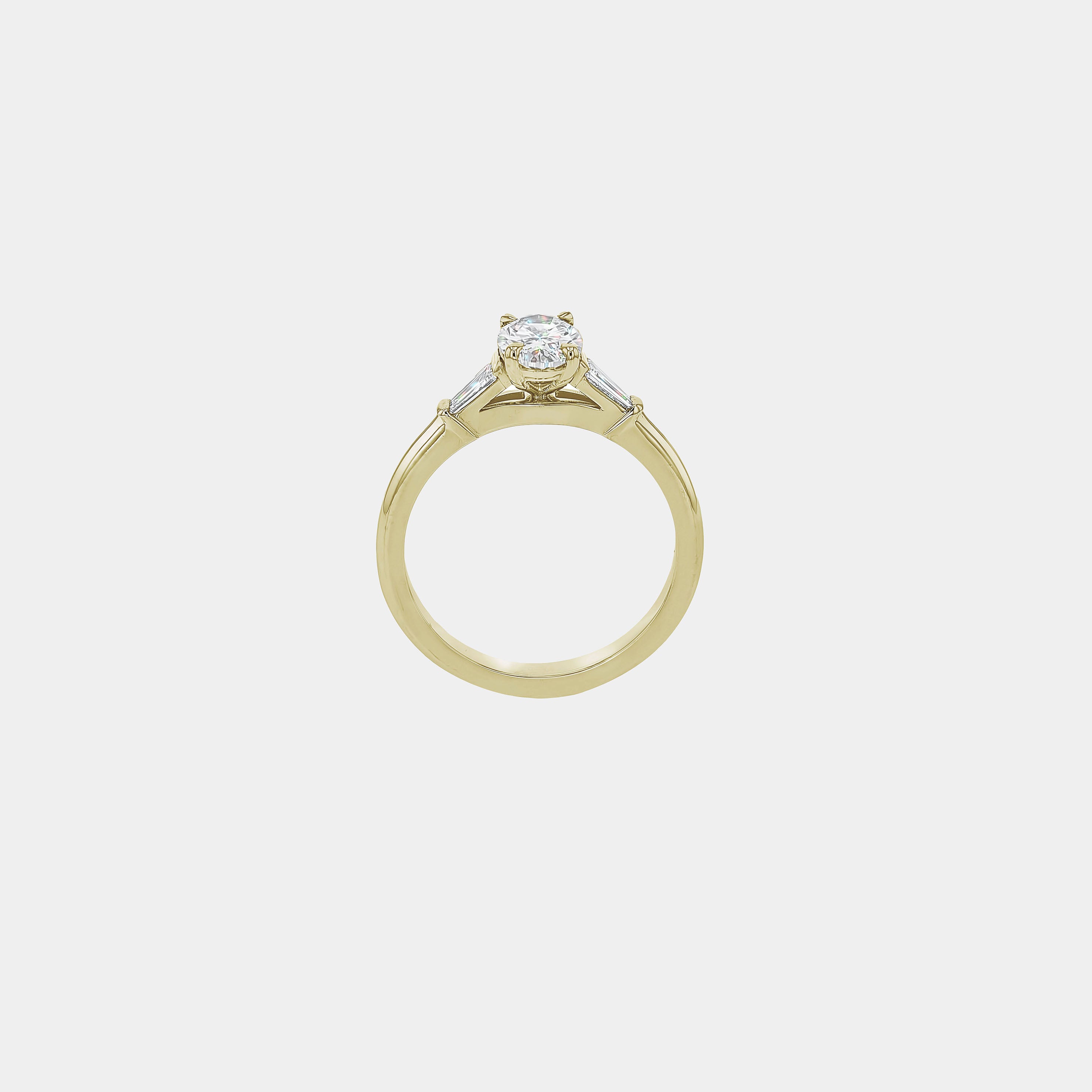Rings-The Willow is a captivating engagement ring. The side tapered baguette cut stones create a beautiful crescendo to the centre oval cut diamond. The thicker band creates a ring that is structured and impactful. Shown paired with the Petite Nadia.-ELIISE MAAR JEWELLERY