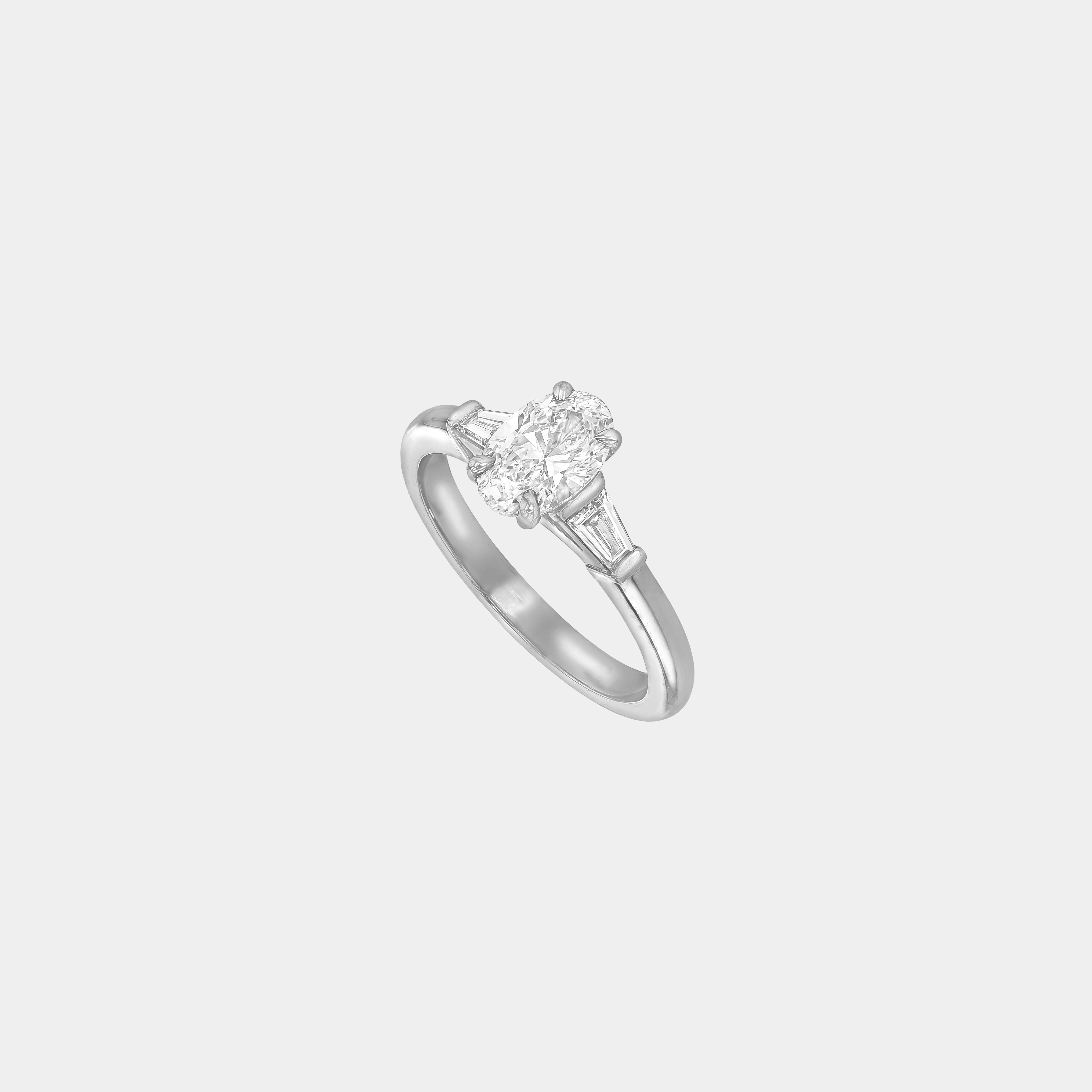 Rings-The Willow is a captivating engagement ring. The side tapered baguette cut stones create a beautiful crescendo to the centre oval cut diamond. The thicker band creates a ring that is structured and impactful. Shown paired with the Petite Nadia.-ELIISE MAAR JEWELLERY