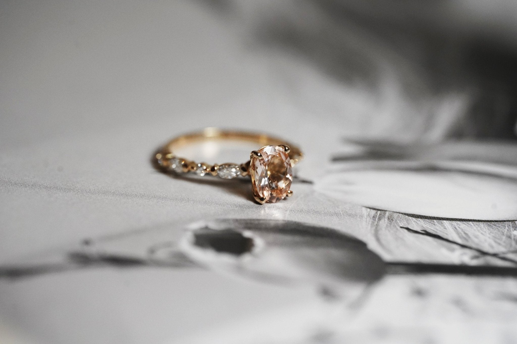 Rings-One of our most beloved designs. The Kelly features a stunning centre morganite surrounded by a band holding marquise and round-cut diamonds. This ring is a stunning reflection of love with its intricate design and endless sparkle. We recommend pairing the Kelly with the Eleni Diamond Band or the Eleanor Diamond Band. Product Details - Featuring a natural 8x6mm peachy-pinky Morganite centre stone- The ring is 2mm thick and 1.80mm wide - The side stones are marquise and round brilliant cut natural diam