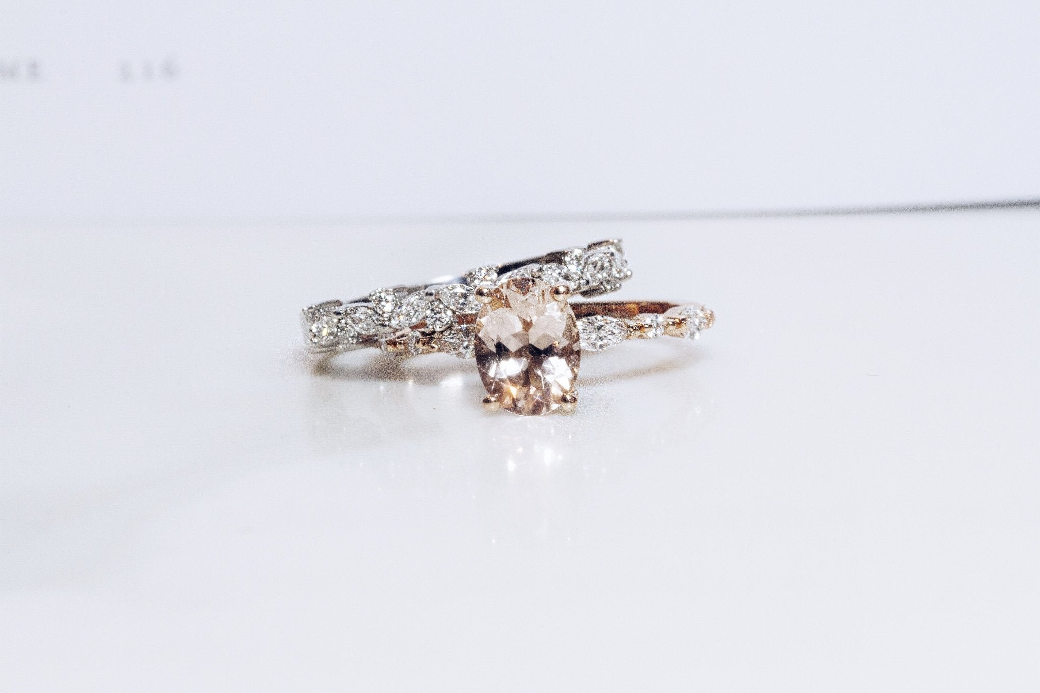 Rings-One of our most beloved designs. The Kelly features a stunning centre morganite surrounded by a band holding marquise and round-cut diamonds. This ring is a stunning reflection of love with its intricate design and endless sparkle. We recommend pairing the Kelly with the Eleni Diamond Band or the Eleanor Diamond Band. Product Details - Featuring a natural 8x6mm peachy-pinky Morganite centre stone- The ring is 2mm thick and 1.80mm wide - The side stones are marquise and round brilliant cut natural diam