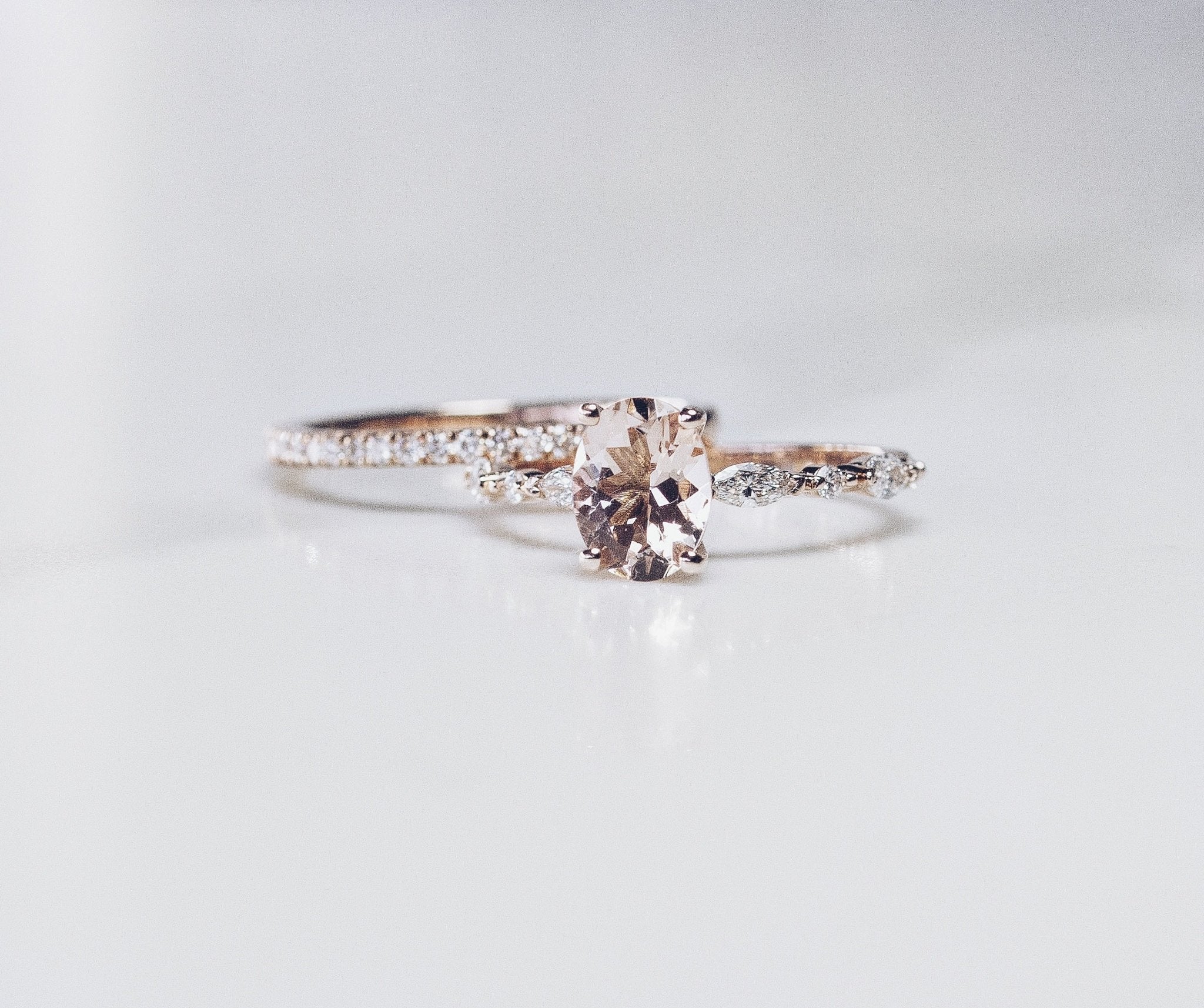 Rings-One of our most beloved designs. The Kelly features a stunning centre morganite surrounded by a band holding marquise and round-cut diamonds. This ring is a stunning reflection of love with its intricate design and endless sparkle. We recommend pairing the Kelly with the Eleni Diamond Band or the Eleanor Diamond Band. Product Details - Featuring a natural 8x6mm peachy-pinky Morganite centre stone- The ring is 2mm thick and 1.80mm wide - The side stones are marquise and round brilliant cut natural diam