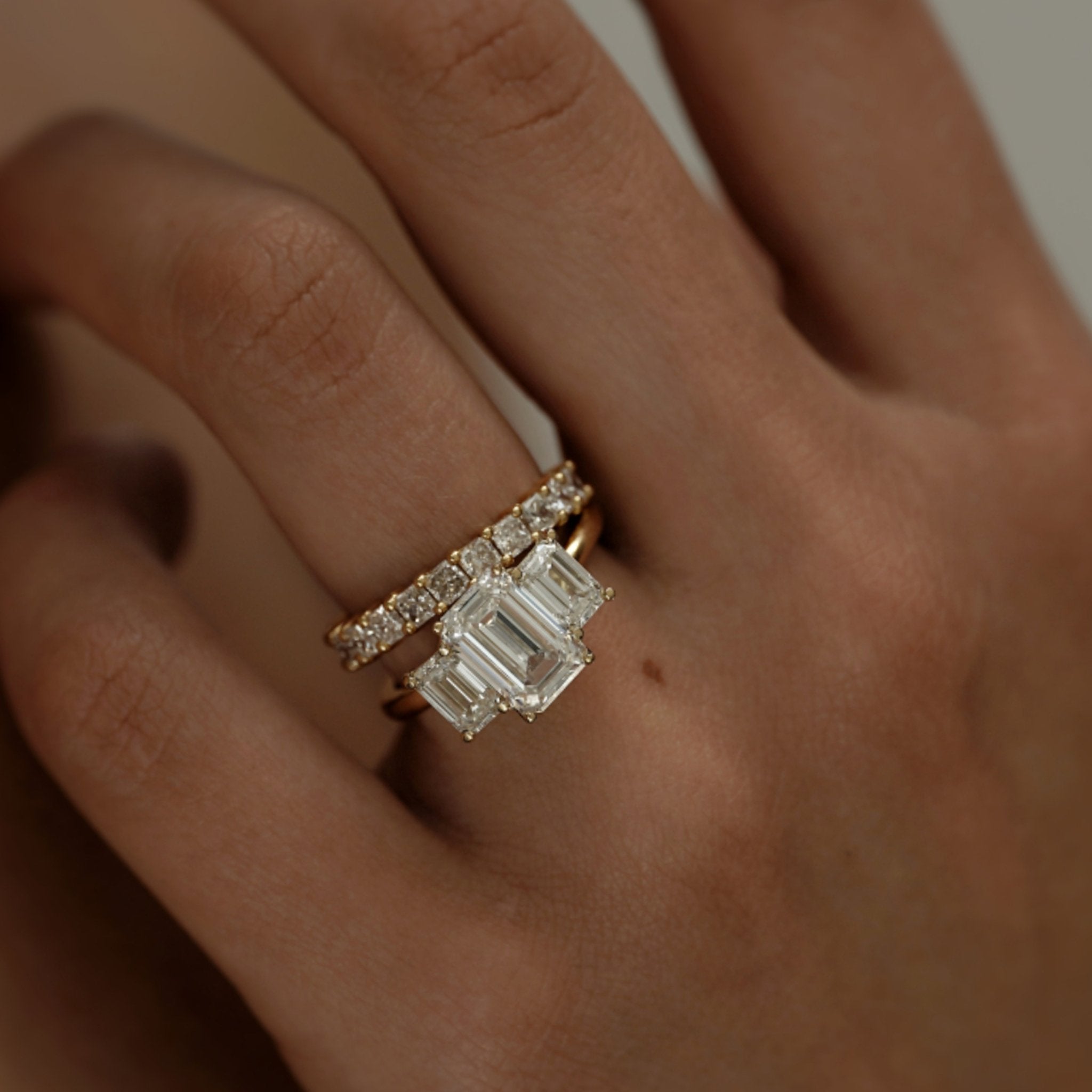 Rings-A stunning trilogy ring featuring three emerald-cut diamonds. Ethereal and breathtaking, this ring is a true testament to the beauty of the emerald-cut diamond. The step cut inside the emerald-cut diamond is famous for its large windows and flashes of bright white light. A ring where the quality and beauty of the diamonds cannot be ignored.-ELIISE MAAR JEWELLERY