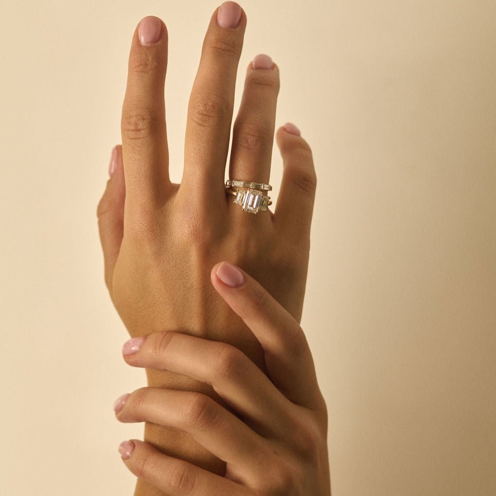 Rings-A stunning trilogy ring featuring three emerald-cut diamonds. Ethereal and breathtaking, this ring is a true testament to the beauty of the emerald-cut diamond. The step cut inside the emerald-cut diamond is famous for its large windows and flashes of bright white light. A ring where the quality and beauty of the diamonds cannot be ignored.-ELIISE MAAR JEWELLERY