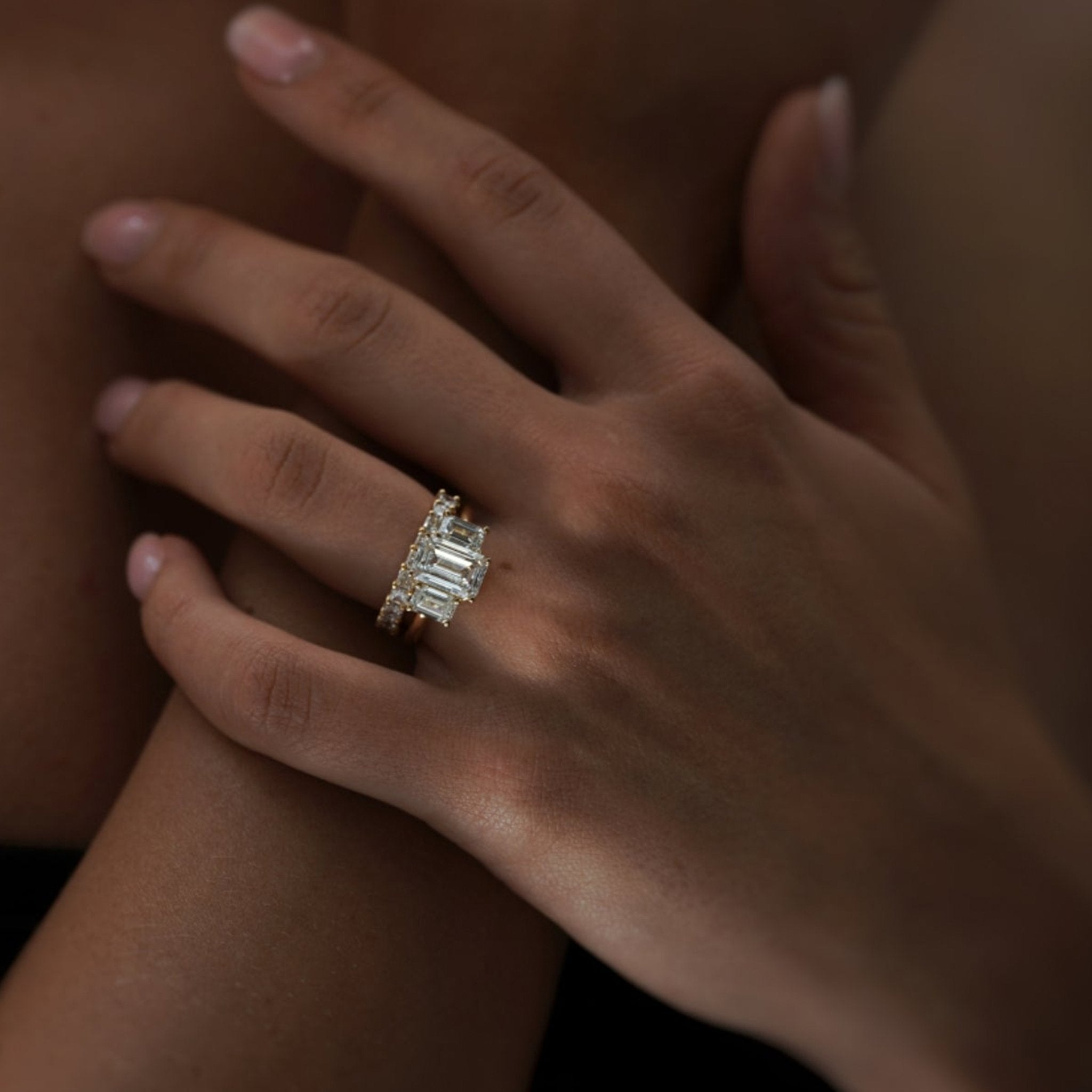 Rings-A stunning trilogy ring featuring three emerald-cut diamonds. Ethereal and breathtaking, this ring is a true testament to the beauty of the emerald-cut diamond. The step cut inside the emerald-cut diamond is famous for its large windows and flashes of bright white light. A ring where the quality and beauty of the diamonds cannot be ignored.-ELIISE MAAR JEWELLERY