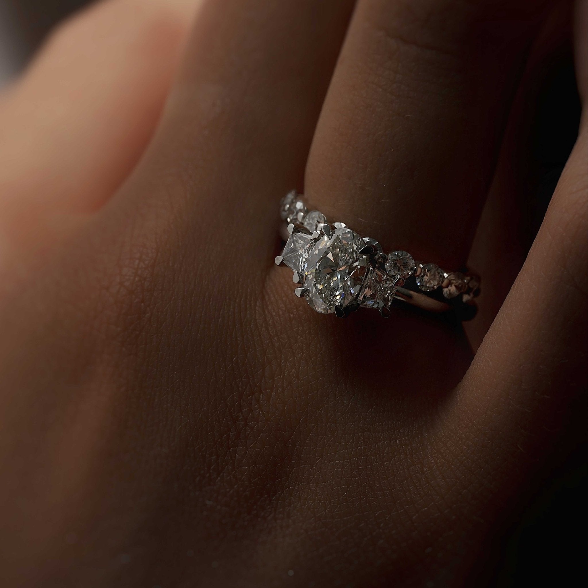 Rings-The Aria is a modern ring with an antique look. The combination of the oval cut centre diamond with the trapeze-cut side stones creates a trilogy that is elegant and striking. A stunning band that pairs well with all wedding bands, we suggest trying with the Josephine Luxe or the Fine Lavish. VIDEO-ELIISE MAAR JEWELLERY