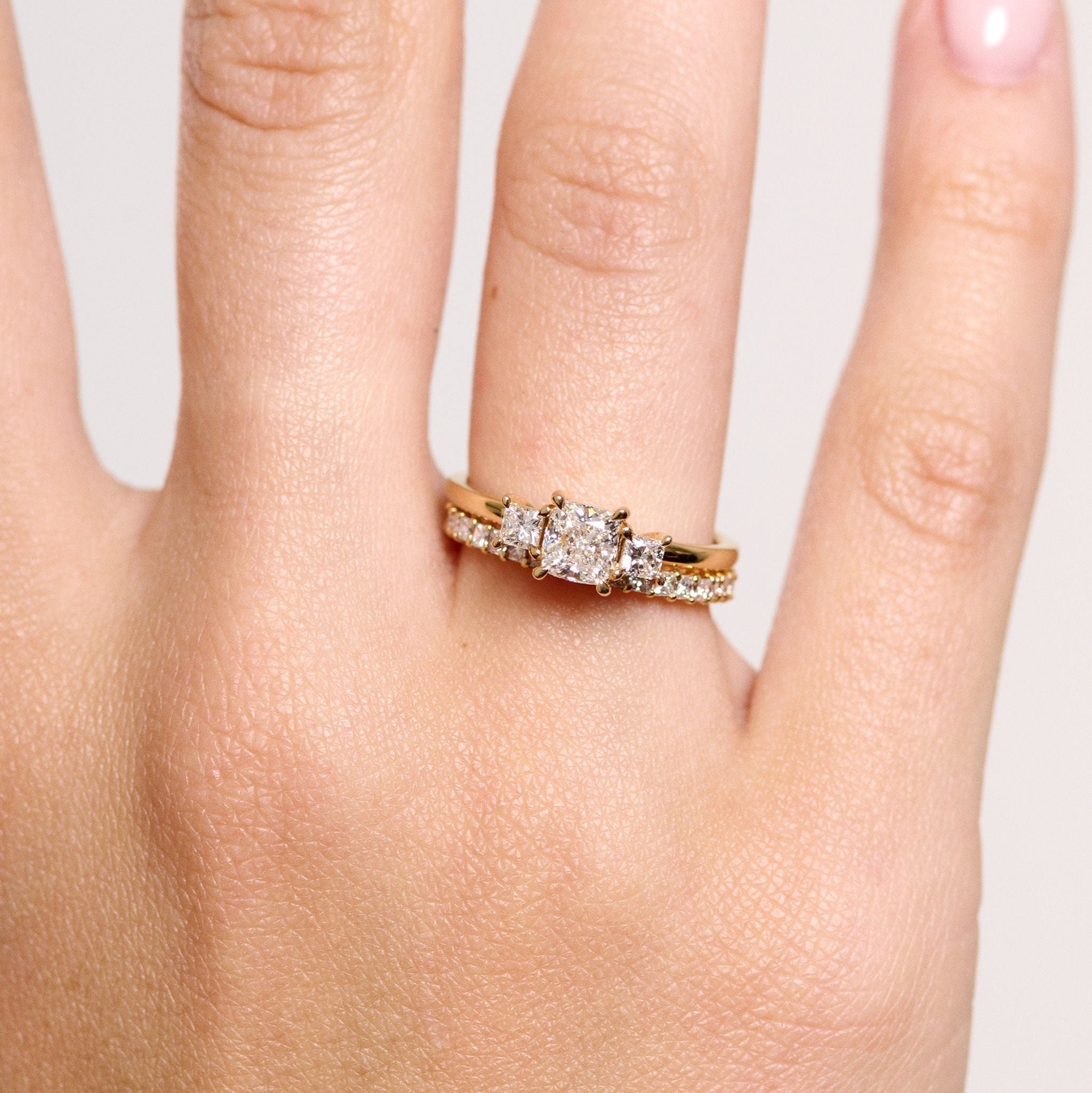 Rings-This elegant trilogy features a cushion cut centre diamond with a brilliant princess cut 0.30ct diamond on either side. VIDEO-ELIISE MAAR JEWELLERY