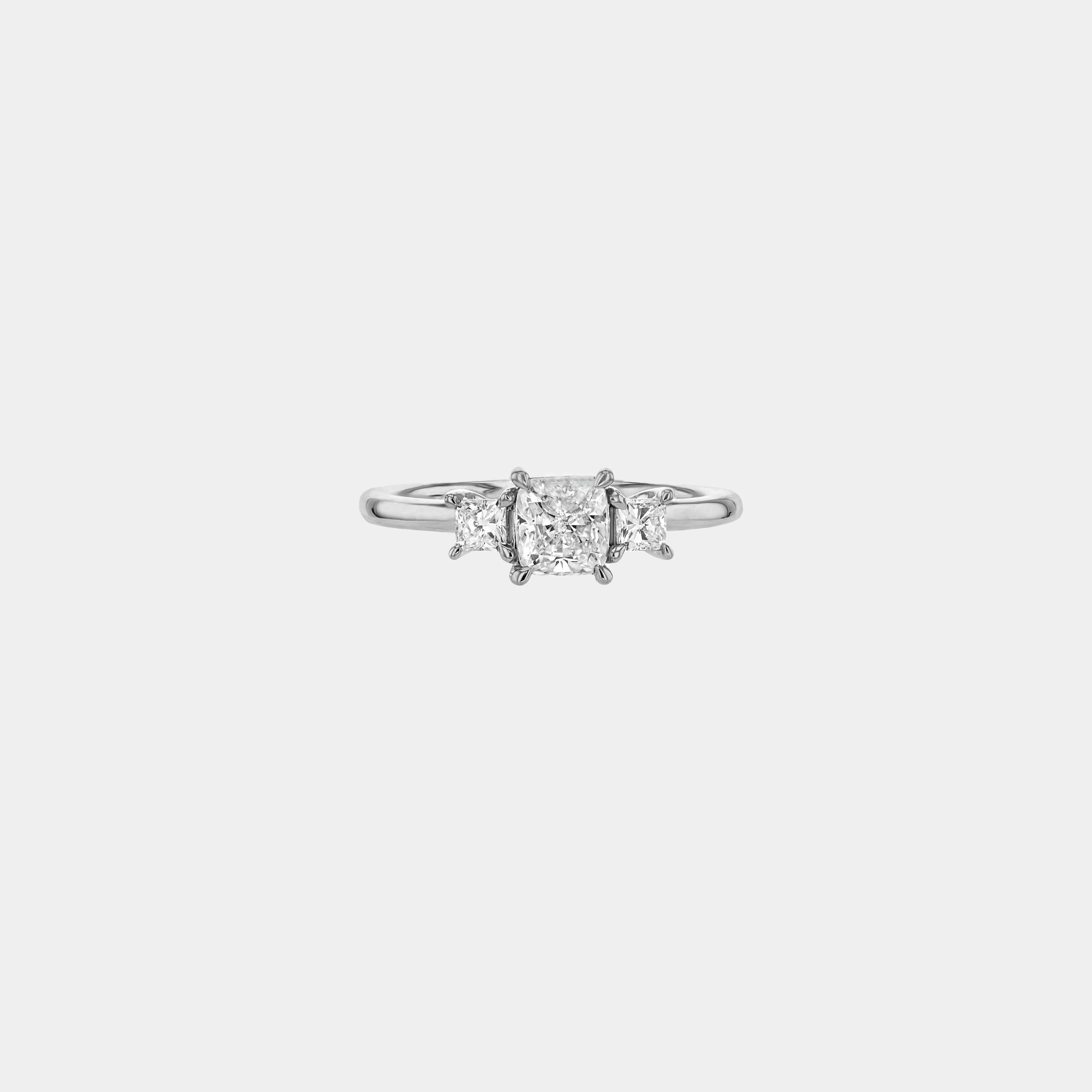 Rings-This elegant trilogy features a cushion cut centre diamond with a brilliant princess cut 0.30ct diamond on either side. VIDEO-ELIISE MAAR JEWELLERY