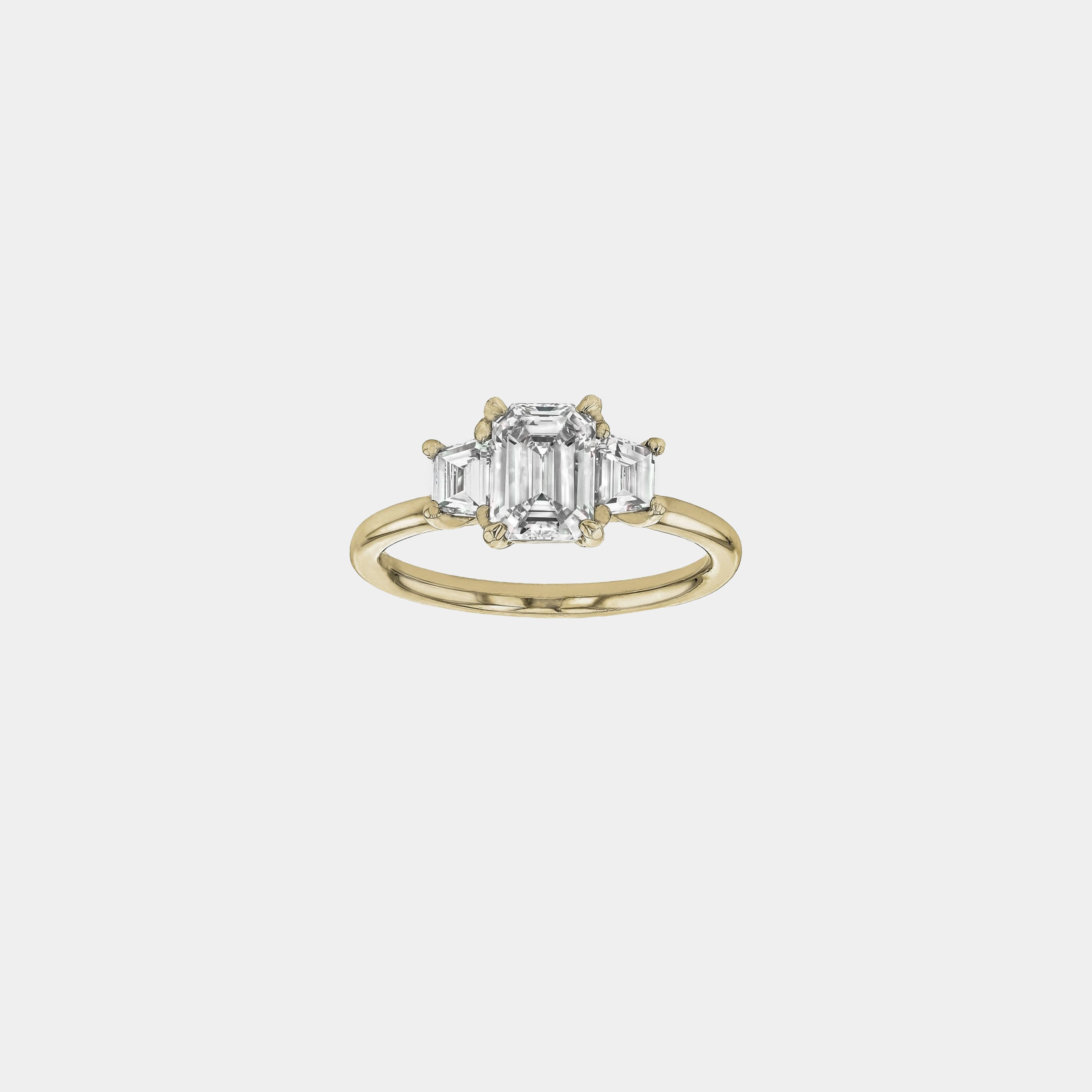 Rings-The Evangeline enhances the intriguing beauty of the emerald-cut diamond with the trapeze cut side stones. The trilogy creates a stunningly geometric shape that is modern and timeless. With the high setting of the stones this engagement ring sits flush with all wedding bands, we recommend pairing with the Bamboo and the Petite Nadia.-ELIISE MAAR JEWELLERY