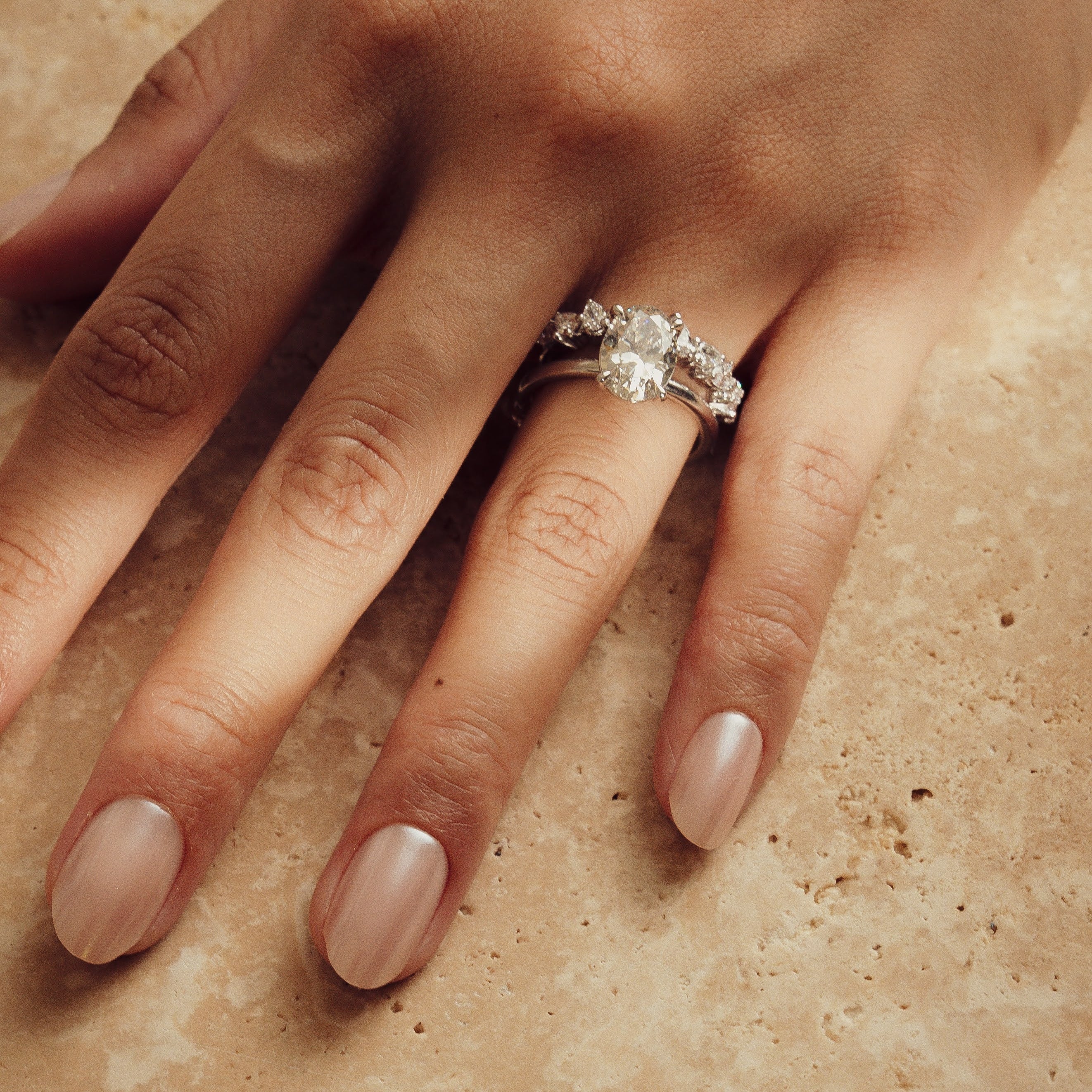 Rings-Drawing inspiration from Grace Kelly, this solitaire ring embodies timeless elegance. Featuring a 4-claw setting and a smoothly rounded band, it offers a subtle frame that highlights the radiant oval diamond at its center. An ideal engagement ring, it complements any wedding band to form a distinctive and personalized set. Shown paired with the 4.0mm Ceremonial Square Band and the Eleanor Luxe Diamond Band.-ELIISE MAAR JEWELLERY