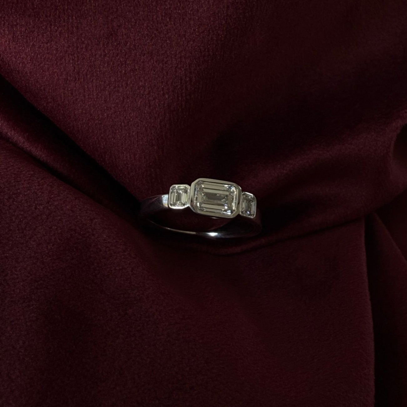 Rings-In the realm of timeless romance, the HERR Diamond Trilogy Ring stands as a beacon of enduring love and shared destiny. Featuring an east-west emerald-cut centre stone, flanked by two complementary emerald-cut diamonds. Cradled in a bezel setting that accentuates their brilliance, the trilogy symbolizes the cherished past, vibrant present, and boundless future of a couple's journey together. As part of the esteemed Le Courage collection, the HERR Diamond Trilogy Ring celebrates the courage inherent in