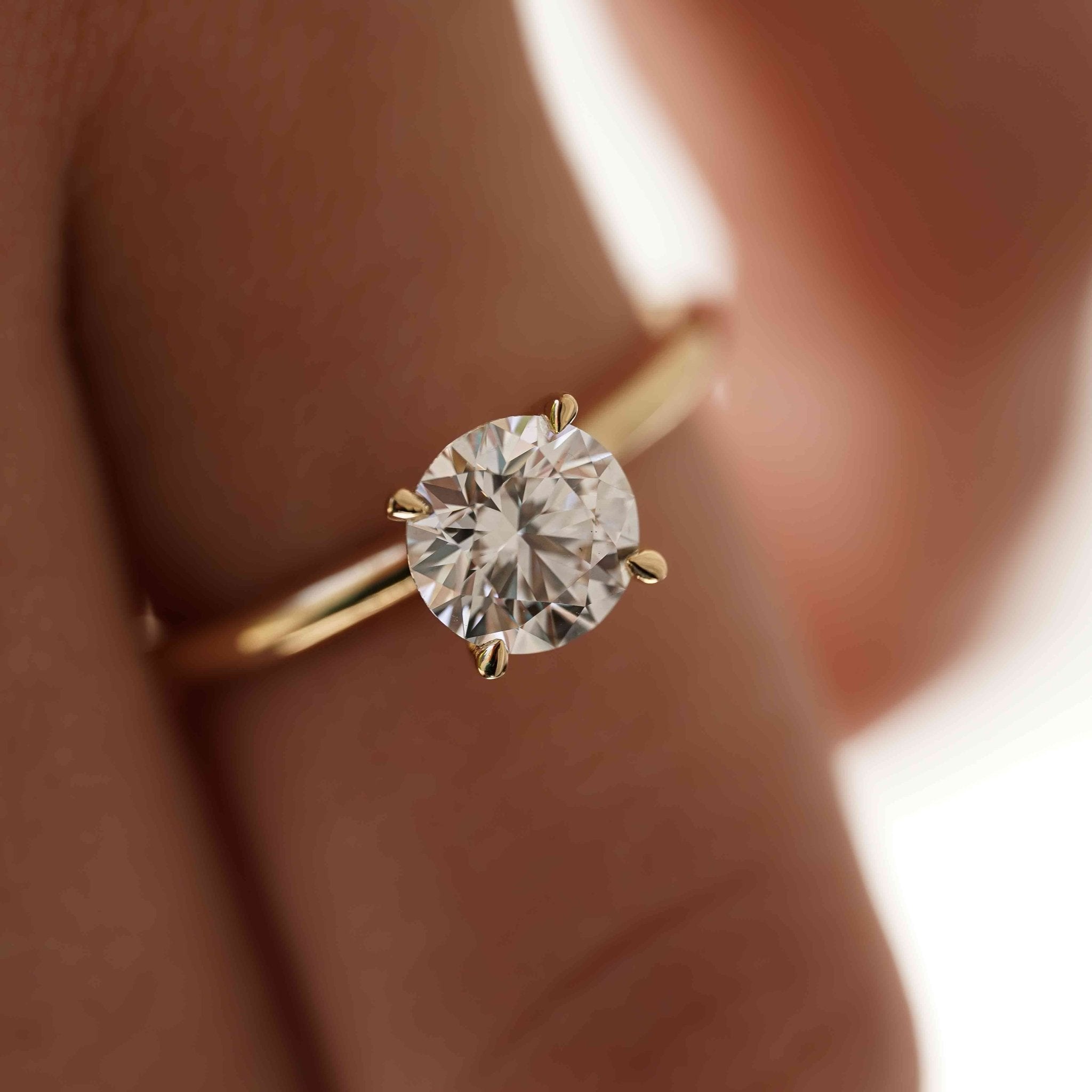 Rings-An elevated solitaire. With a beautiful round cut centre stone and hidden halo on the girdle of the 4 claw basket. The hidden halo provides a beautiful added sparkle to the ring from all angles without interfering with the power of the centre stone. This ring pairs beautifully with wedding bands, we recommend trying the Petite Josephine and the Eleanor.-ELIISE MAAR JEWELLERY