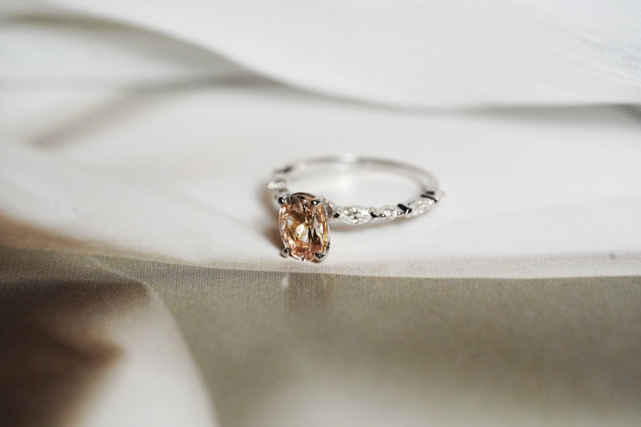Rings-One of our most beloved designs. The Kelly features a stunning centre morganite surrounded by a band holding marquise and round-cut diamonds. This ring is a stunning reflection of love with its intricate design and endless sparkle. We recommend pairing the Kelly with the Eleni Diamond Band or the Eleanor Diamond Band. Product Details - Featuring a natural 8x6mm peachy-pinky Morganite centre stone- The ring is 2mm thick and 1.80mm wide - The side stones are marquise and round brilliant cut natural diam