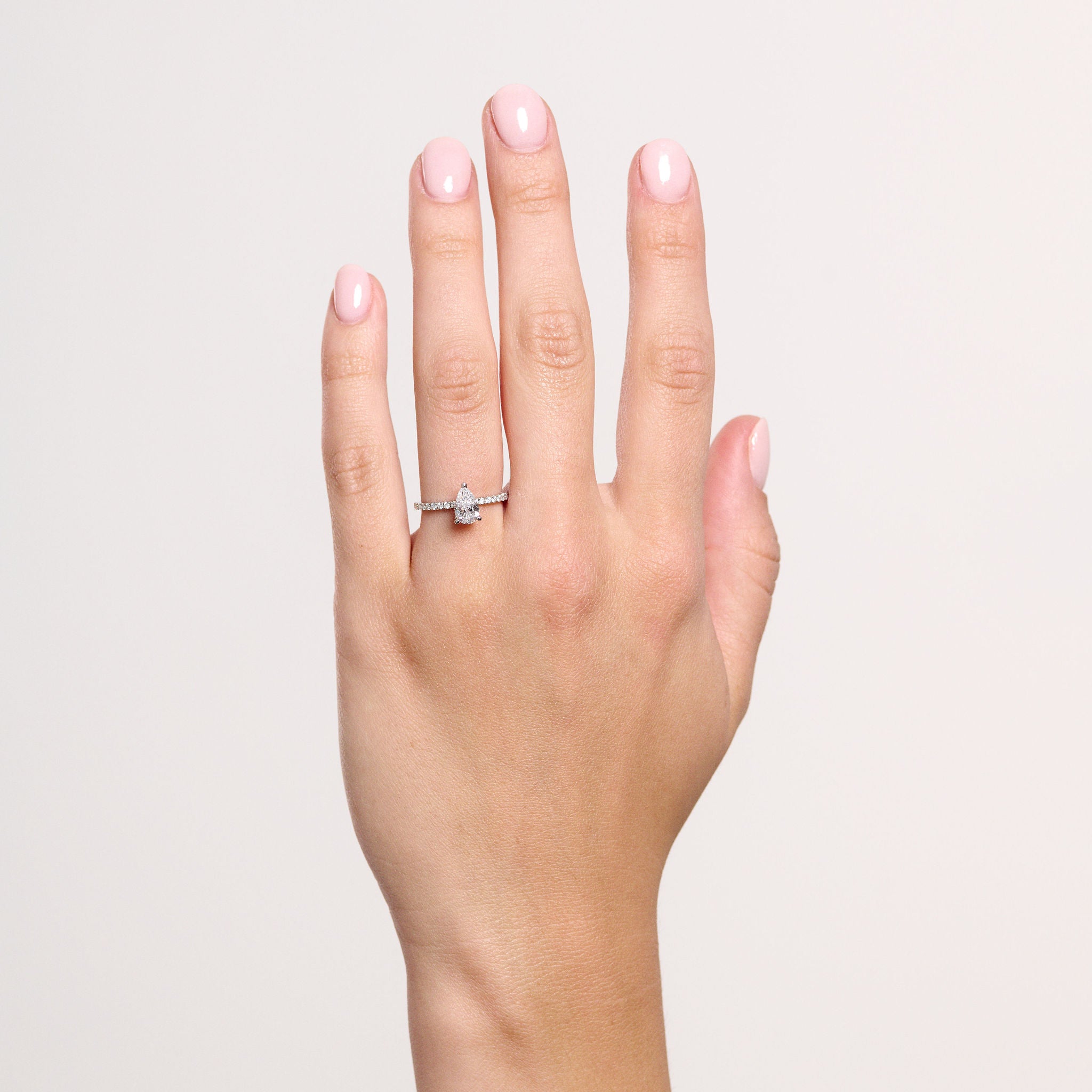 Rings-A elegant engagement ring with a beautiful half eternity pavé diamond band. The striking fire of the side diamonds enhance the brilliance of the oval cut centre diamond. Pair the Lena with with Fine Lavish diamond band for a matching set. Available with an oval or pear shaped diamond.-ELIISE MAAR JEWELLERY