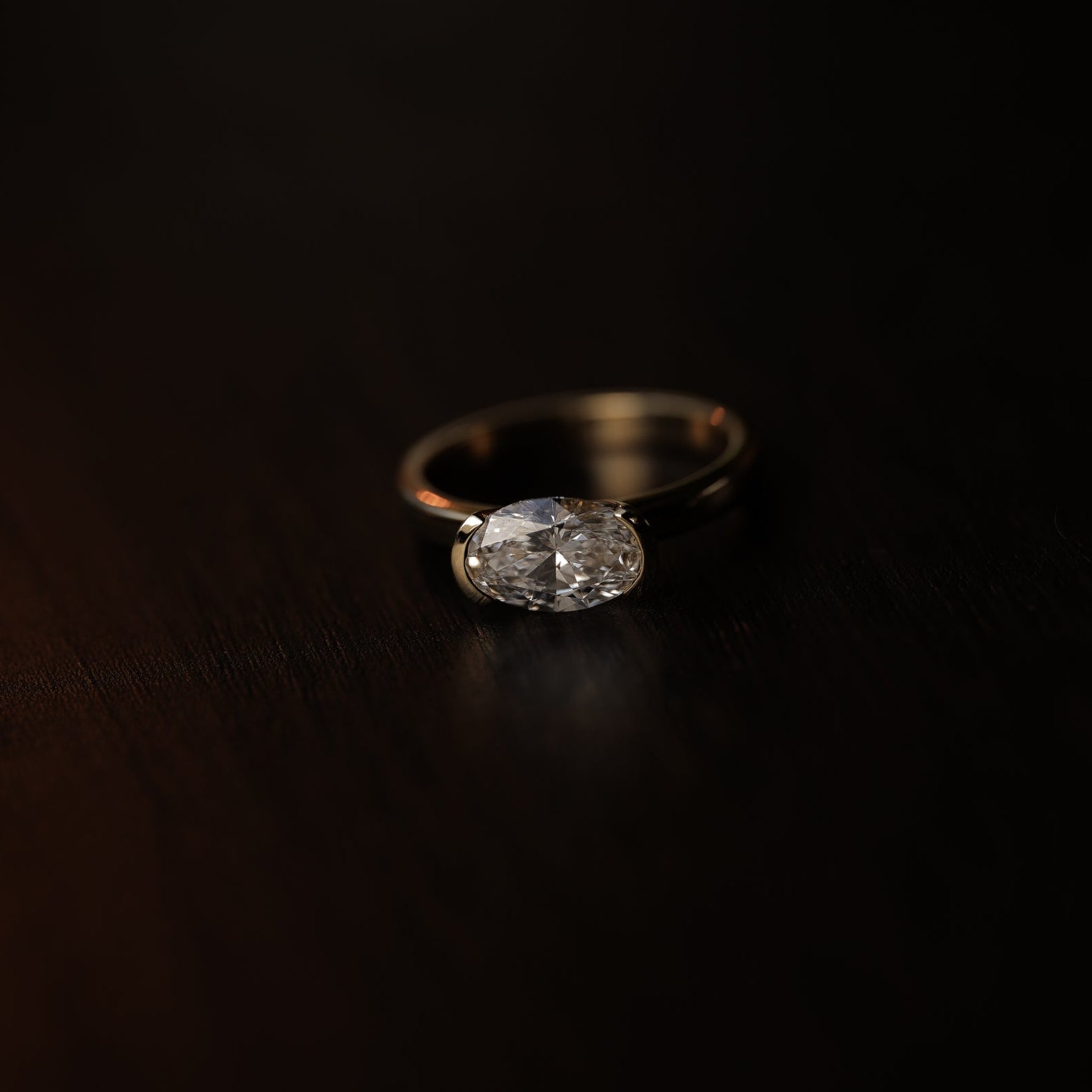 Rings-A contemporary take on the classic solitaire, the Margot is designed for the modern wearer. With an east-west set oval cut center diamond on a thick band, this ring is bold and sleek. See the Margot paired with the Josephine Luxe Diamond Band. Available with different size oval diamonds. Product images featuring an option with 1.00ct center diamond and 0.70ct diamond.-ELIISE MAAR JEWELLERY