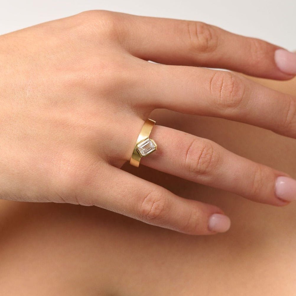 Rings-Part of the Le Courage collection, the Morgan is inspired by the powerful Celtic Goddess of War, Fate and Death who is called on for protection and inspiration. The strong straight windows of the emerald cut stone on the thick gold band pay homage to the courage and strength this mysterious goddess represents.-ELIISE MAAR JEWELLERY