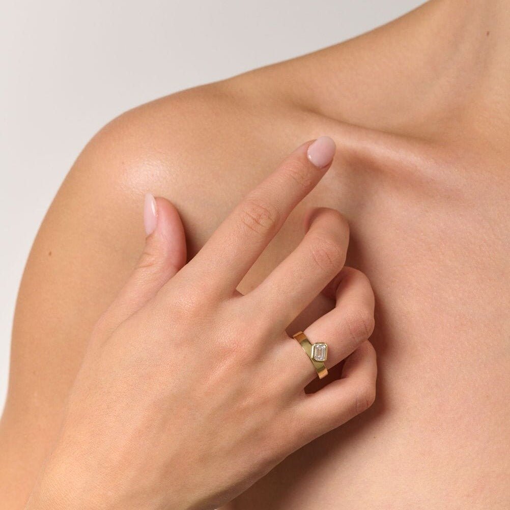 Rings-Part of the Le Courage collection, the Morgan is inspired by the powerful Celtic Goddess of War, Fate and Death who is called on for protection and inspiration. The strong straight windows of the emerald cut stone on the thick gold band pay homage to the courage and strength this mysterious goddess represents.-ELIISE MAAR JEWELLERY