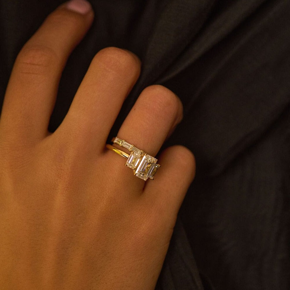 Rings-A stunning trilogy ring featuring three emerald-cut diamonds. Ethereal and breathtaking, this ring is a true testament to the beauty of the emerald-cut diamond. The step cut inside the emerald-cut diamond is famous for its large windows and flashes of bright white light. A ring where the quality and beauty of the diamonds cannot be ignored.-ELIISE MAAR JEWELLERY
