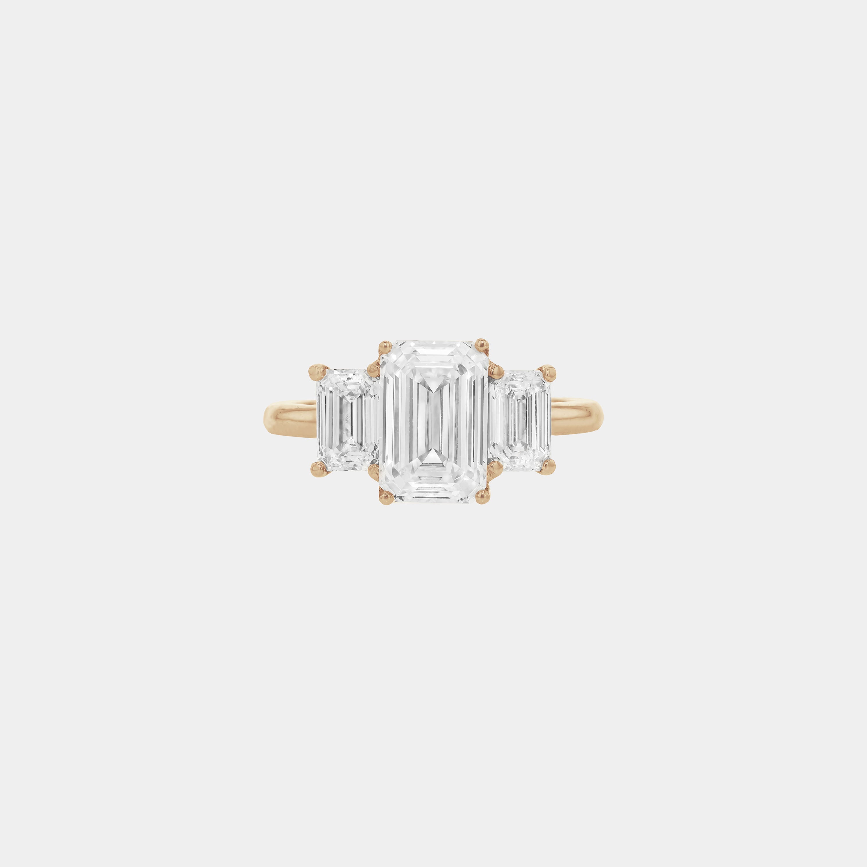 Rings-A stunning trilogy ring featuring three emerald-cut diamonds. Ethereal and breathtaking, this ring is a true testament to the beauty of the emerald-cut diamond. The step cut inside the emerald-cut diamond is famous for its large windows and flashes of bright white light. A ring where the quality and beauty of the diamonds cannot be ignored.-ELIISE MAAR JEWELLERY