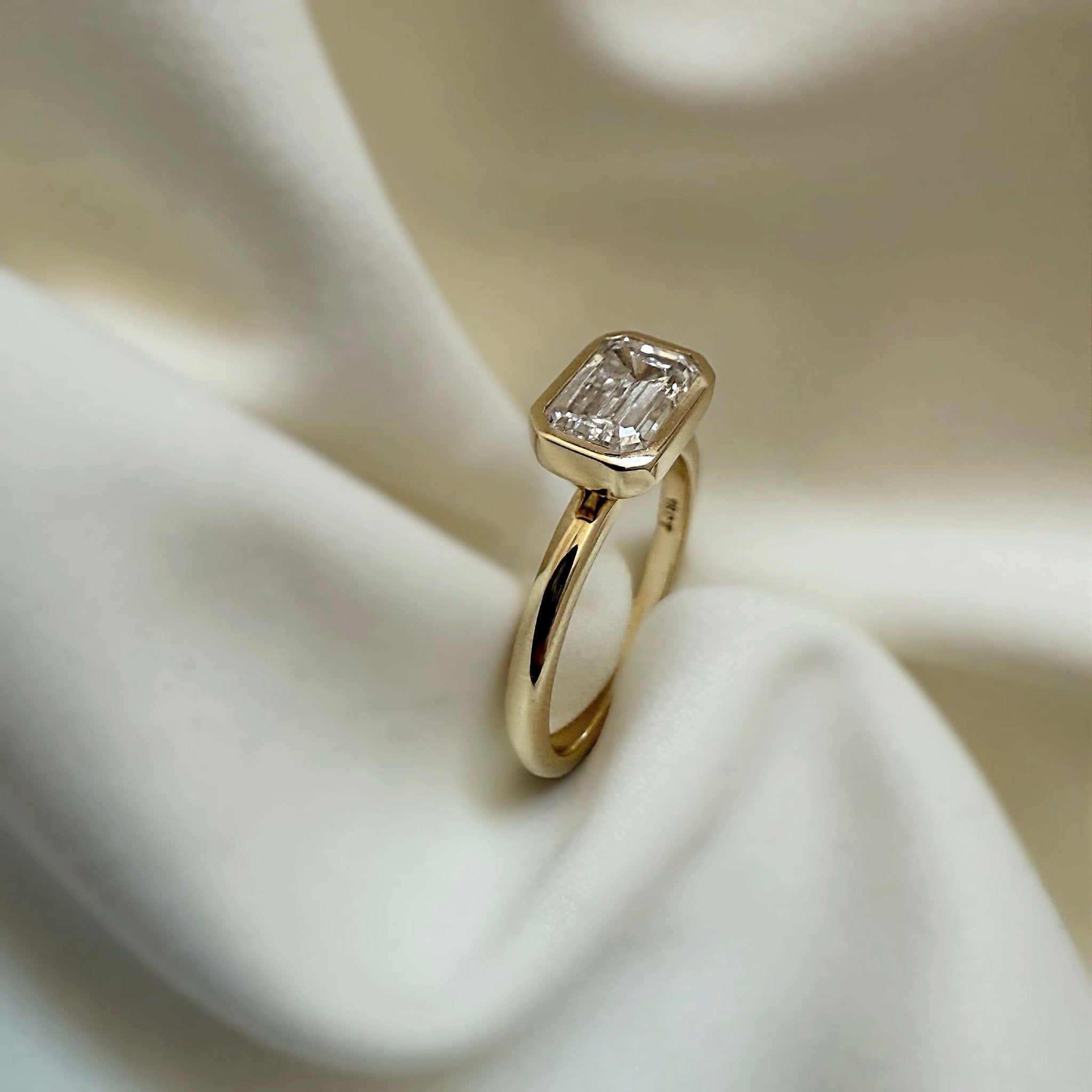 Rings-The Stephanie is truly effortless and timeless. The full bezel setting around the emerald cut diamond makes this ring unique and bold. Fall in love forever with this stunning design.-ELIISE MAAR JEWELLERY