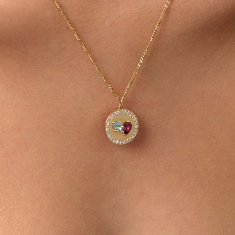 Necklaces-This enchanting heart shaped birthstone necklace looks like a spark of celestial beauty. Two individual, sparkling pear-shaped stones, customizable to each of your beloved's birth months. Other Half Birthstone Medallion- Features 6x4 Pear Cut Gemstones (total carat weigh 1.00ct) and approximately 0.35ct of natural white F/SI1 round diamonds. JANUARY Garnet FEBRUARY Amethyst MARCH Aquamarine APRIL Diamond MAY Emerald JUNE Pearl JULY Ruby AUGUST Peridot SEPTEMBER Sapphire OCTOBER Tourmaline NOVEMBER