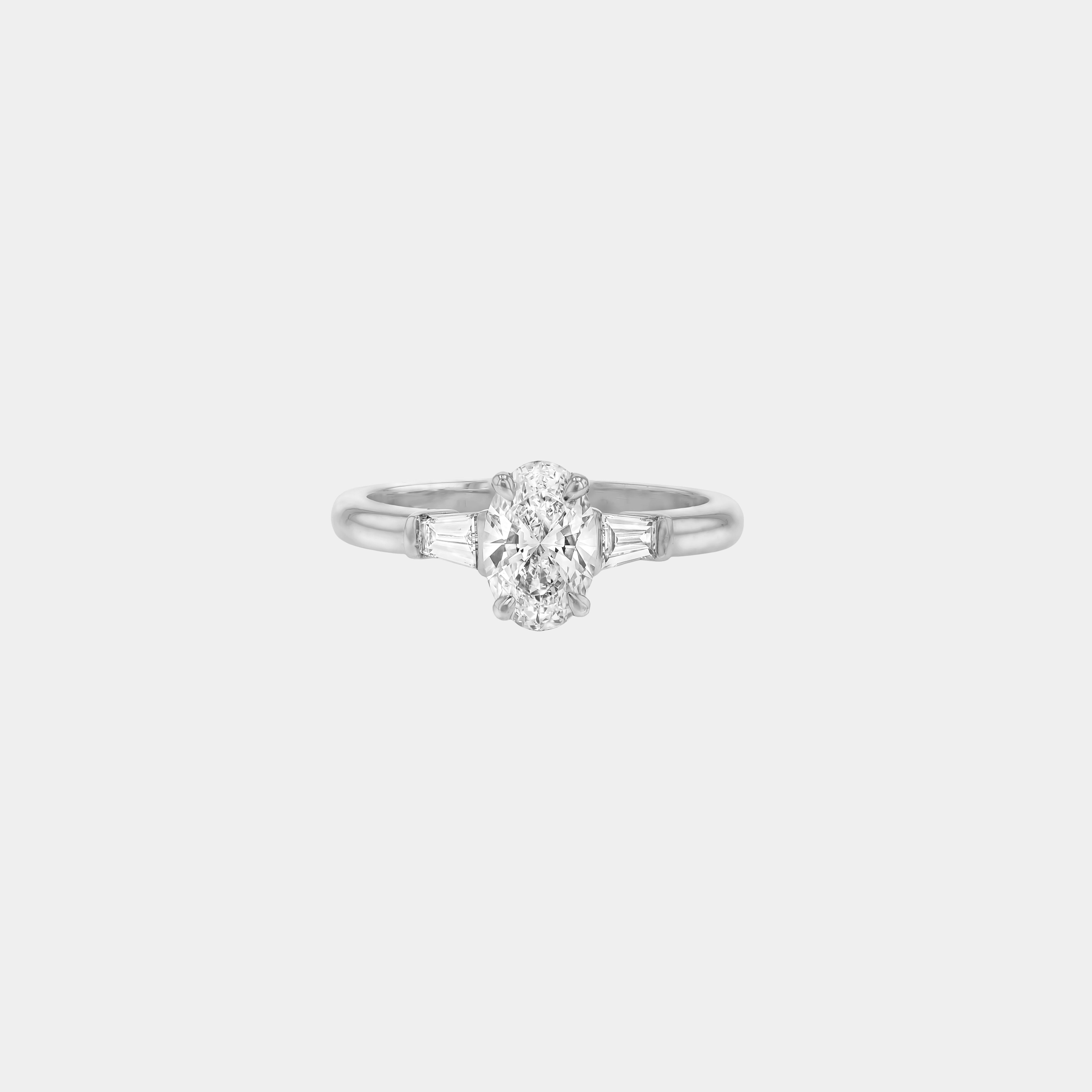 Rings-The Willow is a captivating engagement ring. The side tapered baguette cut stones create a beautiful crescendo to the centre oval cut diamond. The thicker band creates a ring that is structured and impactful. Shown paired with the Petite Nadia.-ELIISE MAAR JEWELLERY