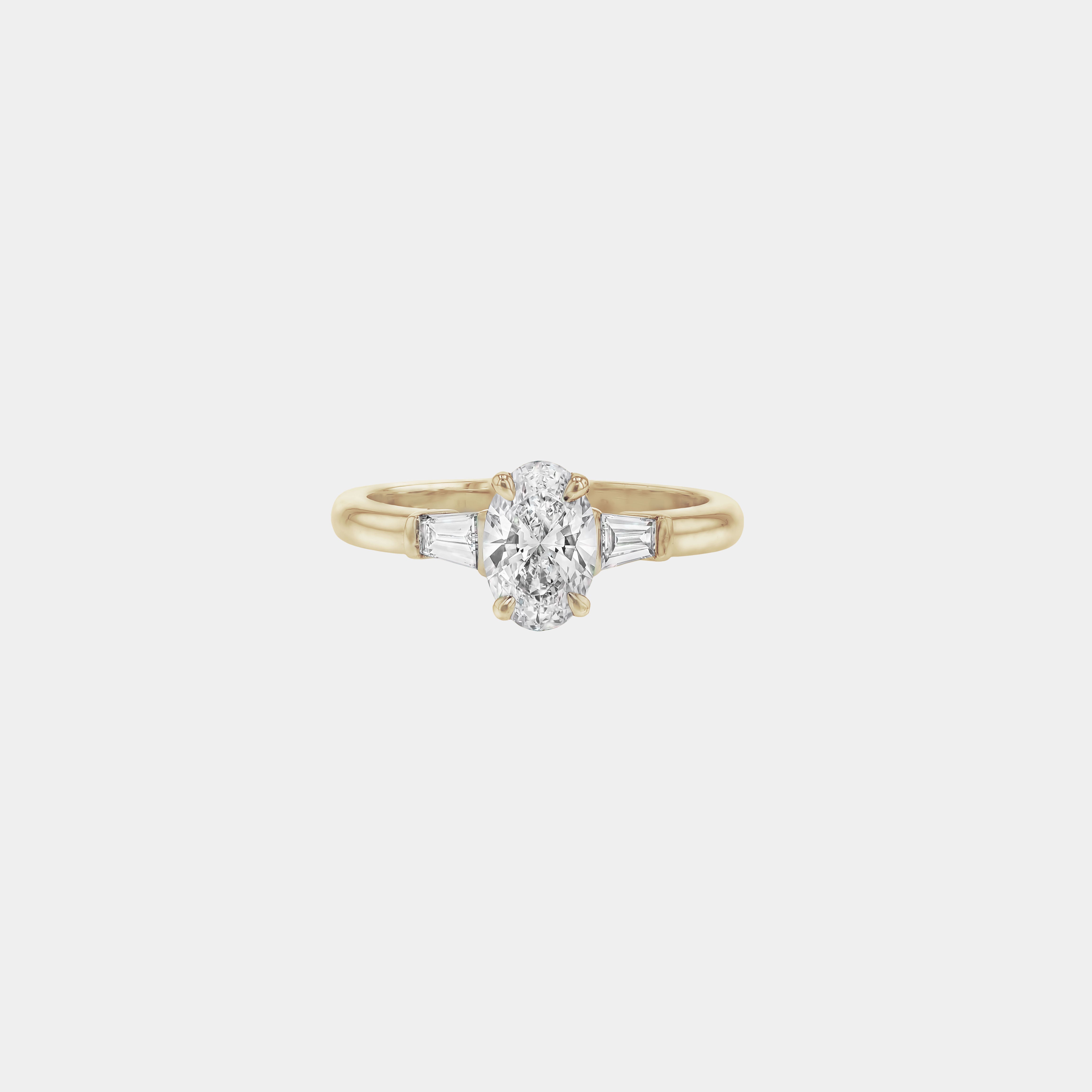 Rings-The Willow is a captivating engagement ring. The side tapered baguette cut stones create a beautiful crescendo to the centre oval cut diamond. The thicker band creates a ring that is structured and impactful. Shown paired with the Petite Nadia.-ELIISE MAAR JEWELLERY