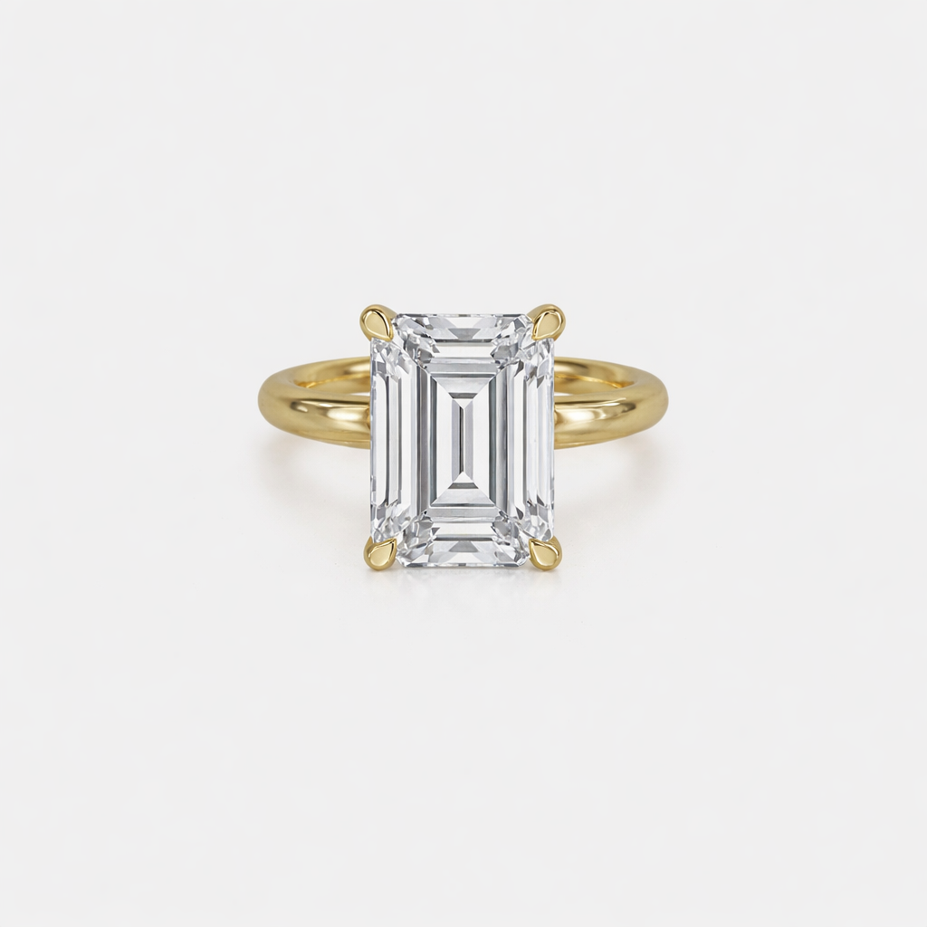 Gold ring with a large rectangular diamond on a light gray background