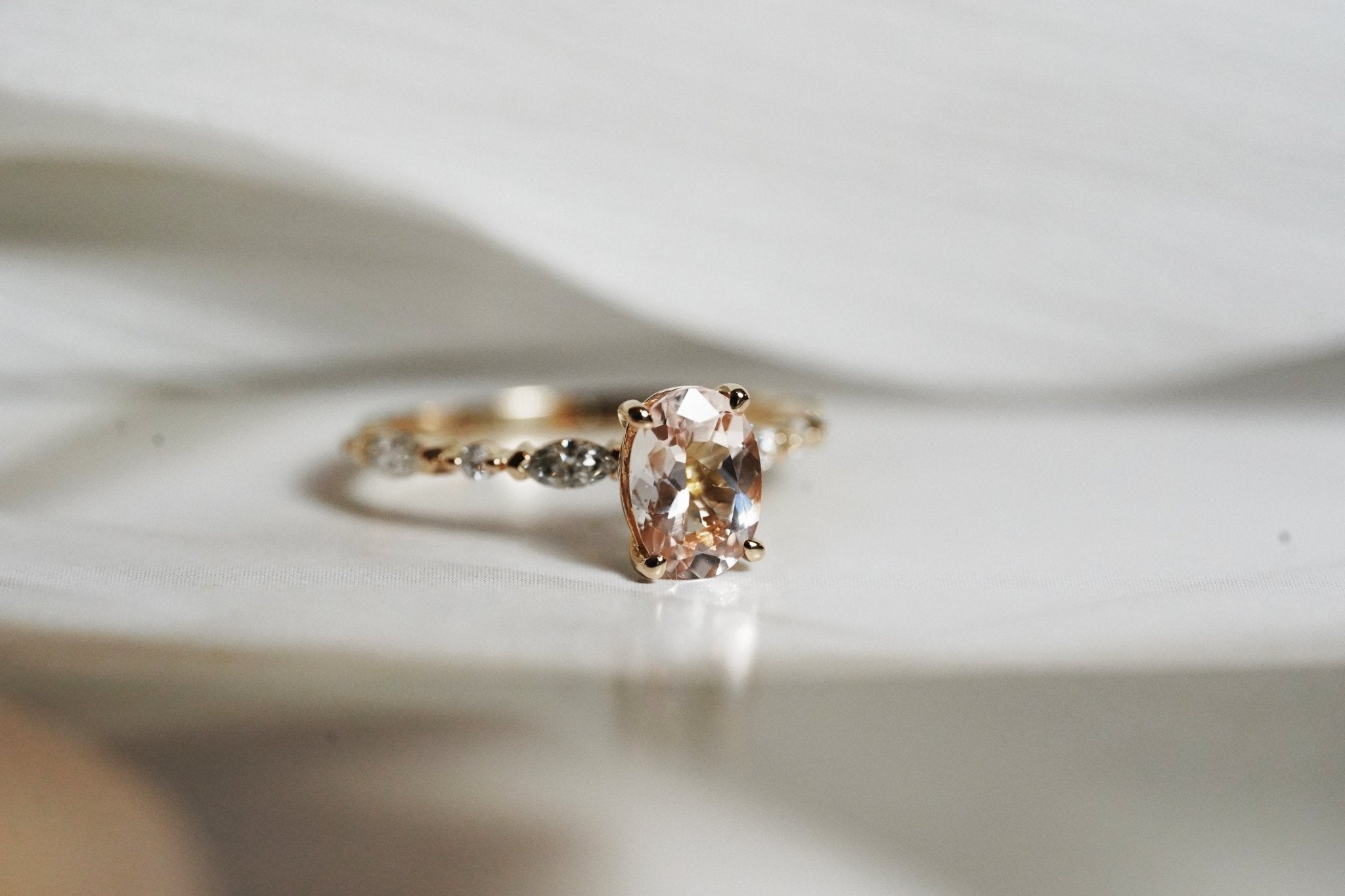 Rings-One of our most beloved designs. The Kelly features a stunning centre morganite surrounded by a band holding marquise and round-cut diamonds. This ring is a stunning reflection of love with its intricate design and endless sparkle. We recommend pairing the Kelly with the Eleni Diamond Band or the Eleanor Diamond Band. Product Details - Featuring a natural 8x6mm peachy-pinky Morganite centre stone- The ring is 2mm thick and 1.80mm wide - The side stones are marquise and round brilliant cut natural diam