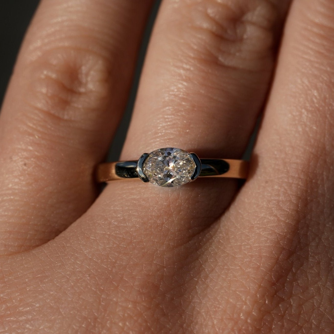 Rings-A contemporary take on the classic solitaire, the Margot is designed for the modern wearer. With an east-west set oval cut center diamond on a thick band, this ring is bold and sleek. See the Margot paired with the Josephine Luxe Diamond Band. Available with different size oval diamonds. Product images featuring an option with 1.00ct center diamond and 0.70ct diamond.-ELIISE MAAR JEWELLERY