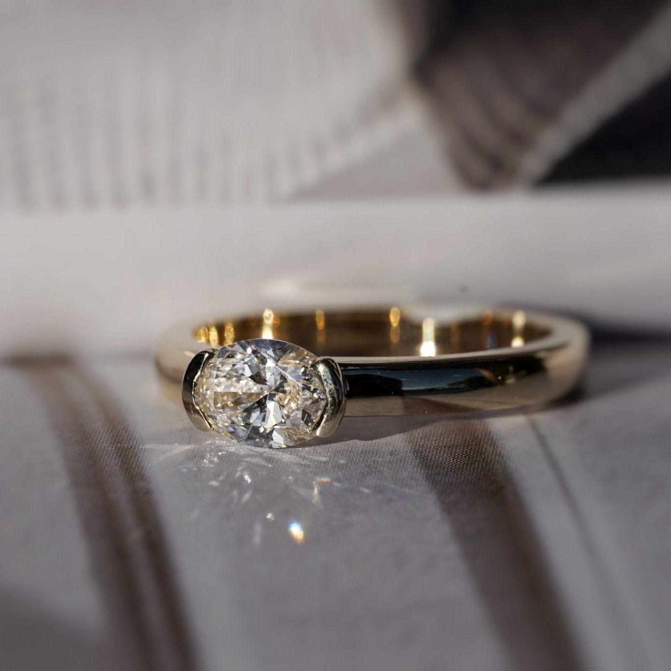 Rings-A contemporary take on the classic solitaire, the Margot is designed for the modern wearer. With an east-west set oval cut center diamond on a thick band, this ring is bold and sleek. See the Margot paired with the Josephine Luxe Diamond Band. Available with different size oval diamonds. Product images featuring an option with 1.00ct center diamond and 0.70ct diamond.-ELIISE MAAR JEWELLERY