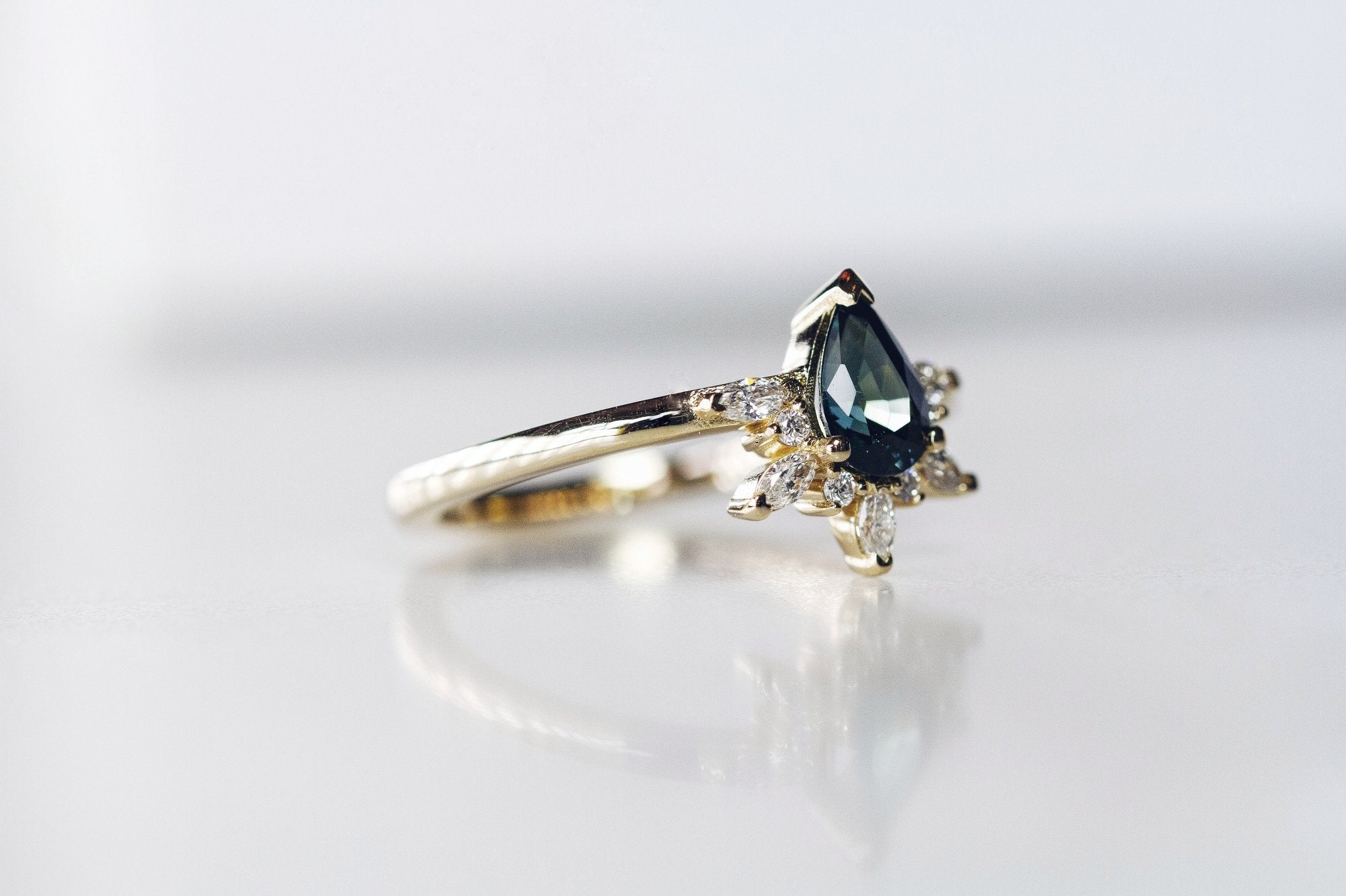 Rings-Feminine, nostalgic nod to the beauty, timelessness and grace of what it means to be woman. Centre stone is a stunning Australian Sapphire completed with a divine diamond halo. Destined to be your forever obsession. Product Details - Features a 0.70ct natural deep blue Australian Sapphire- Half halo features marquise and round F/SI1 natural diamonds (approximately 0.20ct)- Shop the Natasha Diamond Crown to complete the set- The ring is 1.85mm wide and 1.6mm thick-ELIISE MAAR JEWELLERY