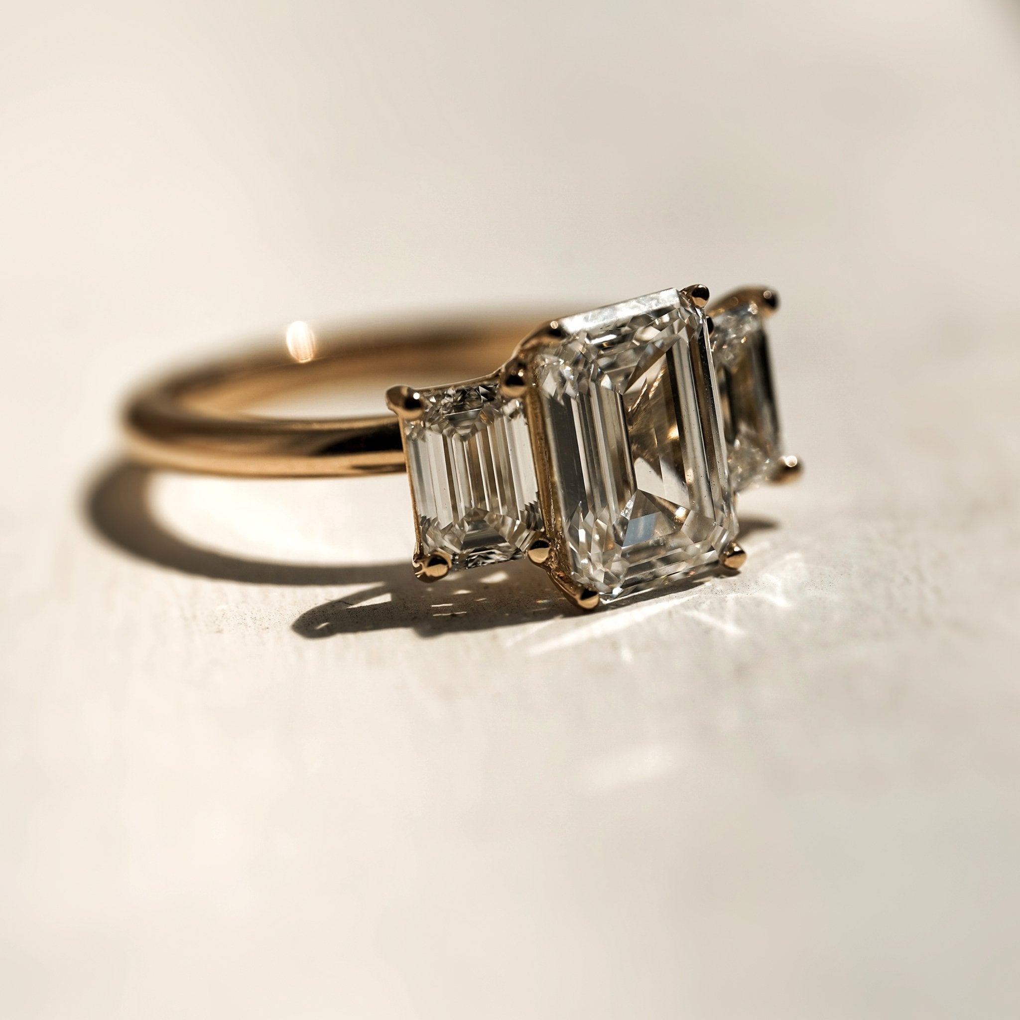 Rings-A stunning trilogy ring featuring three emerald-cut diamonds. Ethereal and breathtaking, this ring is a true testament to the beauty of the emerald-cut diamond. The step cut inside the emerald-cut diamond is famous for its large windows and flashes of bright white light. A ring where the quality and beauty of the diamonds cannot be ignored.-ELIISE MAAR JEWELLERY