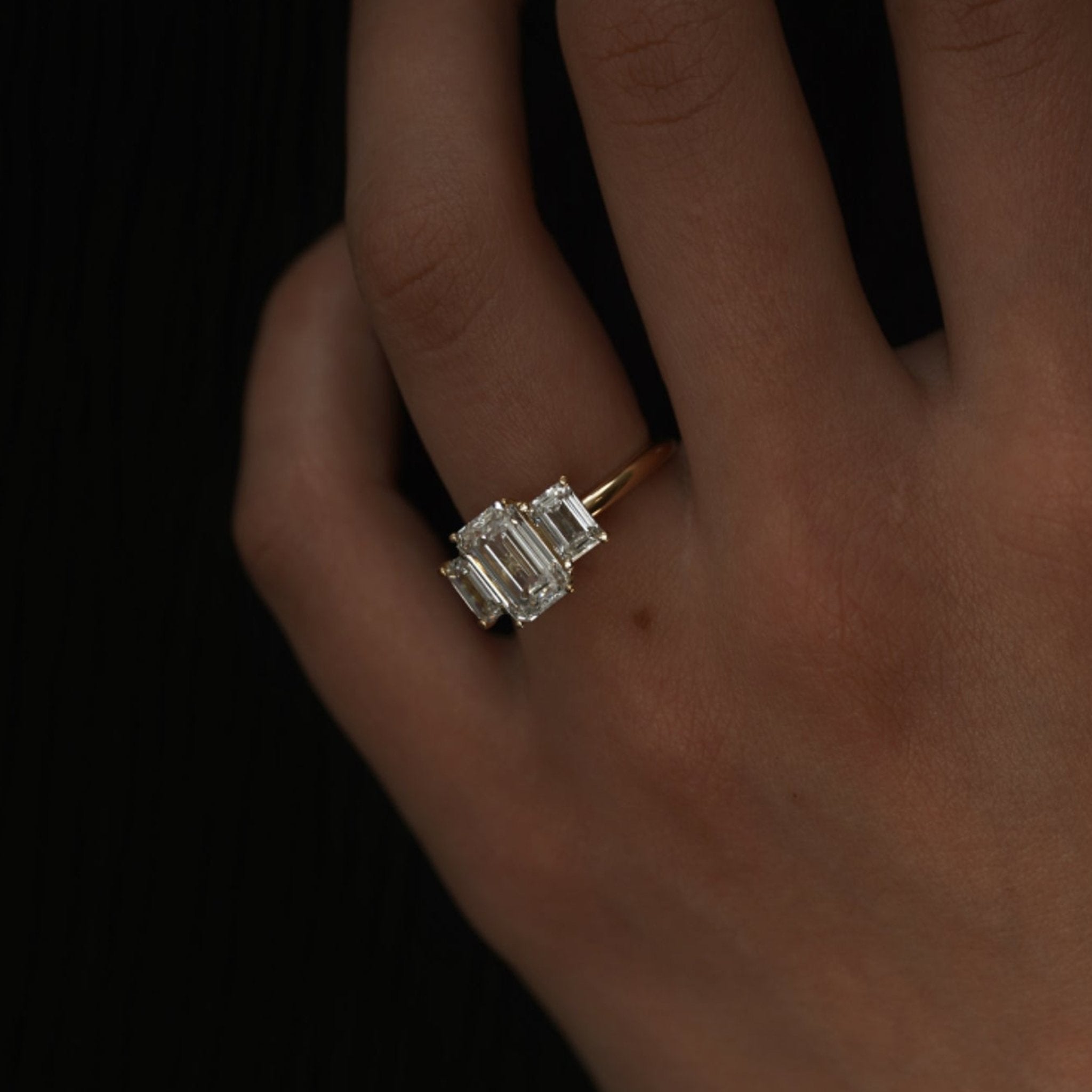 Rings-A stunning trilogy ring featuring three emerald-cut diamonds. Ethereal and breathtaking, this ring is a true testament to the beauty of the emerald-cut diamond. The step cut inside the emerald-cut diamond is famous for its large windows and flashes of bright white light. A ring where the quality and beauty of the diamonds cannot be ignored.-ELIISE MAAR JEWELLERY